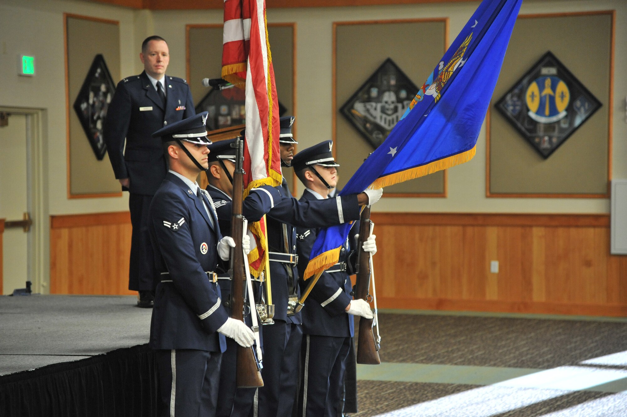 The Malmstrom Air Force Base Honor Guard presents the colors during a remembrance ceremony at the Grizzly Bend on Sept. 11. Chaplain (Capt.) Keith Manry, background, stands at attention before providing the invocation and scripture reading from Psalm 46. (U.S. Air Force photo/John Turner)