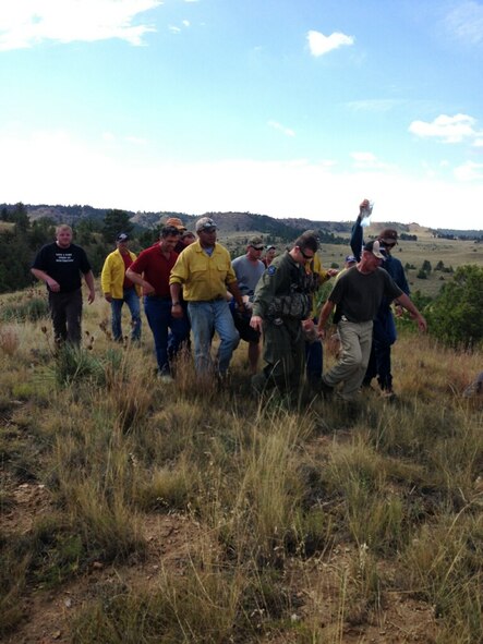 Maj. Kurt Ponsor, 341st Missile Wing flight safety officers, helps carry an injured survivor with more than 30 other local support personnel during a search and rescue mission Sept. 7. (U.S. Air Force photo/Staff Rob Sinyard)
