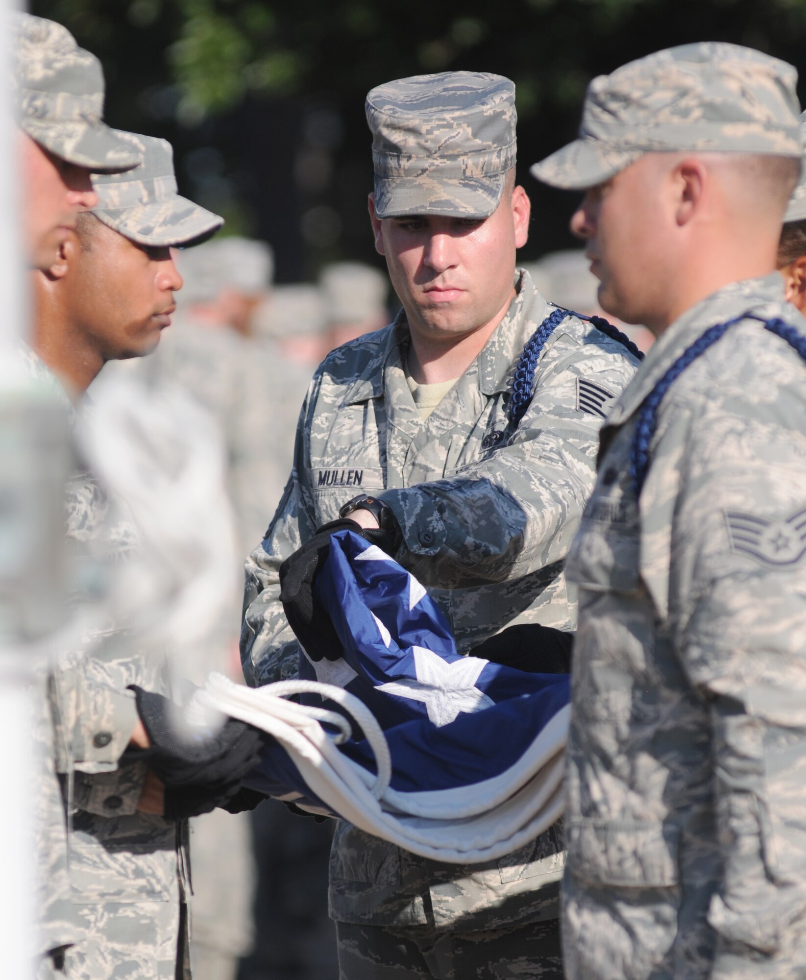 Tech. Sgt. Kyle Mullen, 81st Training Group military training leader, folds the U.S. flag during a retreat ceremony Sept. 11, 2013, Keesler Air Force Base, Miss. The ceremony honored those who lost their lives during the 9/11 attacks.  (U.S. Air Force photo by Kemberly Groue)
