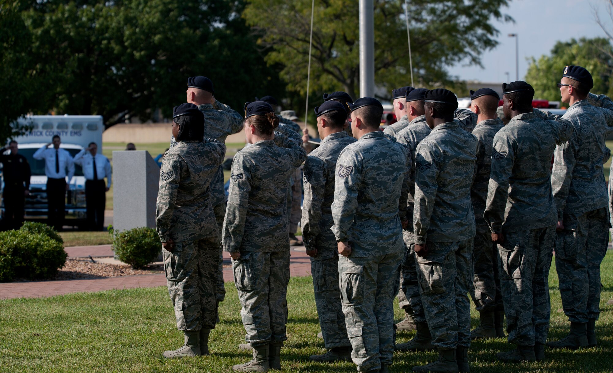 Airmen from the 22nd Security Forces Squadron salute the flag during a Patriot Day ceremony Sept. 11, 2013, at McConnell Air Force Base, Kan. The squadron was one of several formations honoring the fallen heroes of 9/11. (U.S. Air Force photo/Airman 1st Class Victor J. Caputo)