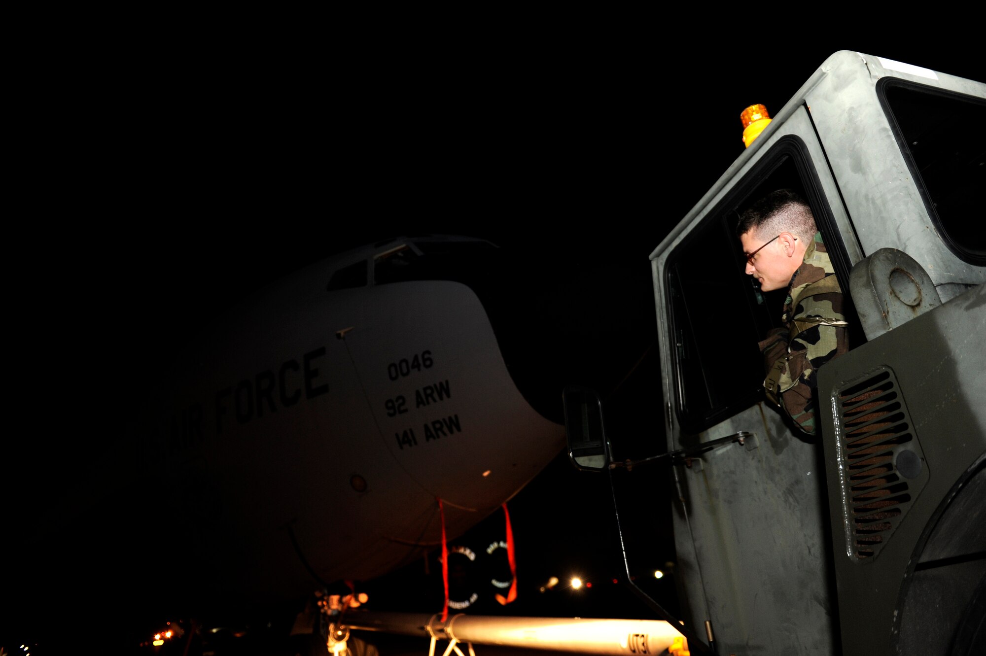 U.S. Air Force Senior Airman Trevor Naismith, 718th Aircraft Maintenance Squadron crew chief, tows a KC-135 Stratotanker on the flightline of Kadena Air Base, Japan, during a local operational readiness exercise Sept. 12, 2013. Kadena Airmen regularly conduct LOREs to improve their capabilities in support of the common defense of the Asia-Pacific region. (U.S. Air Force photo by Senior Airman Maeson L. Elleman)