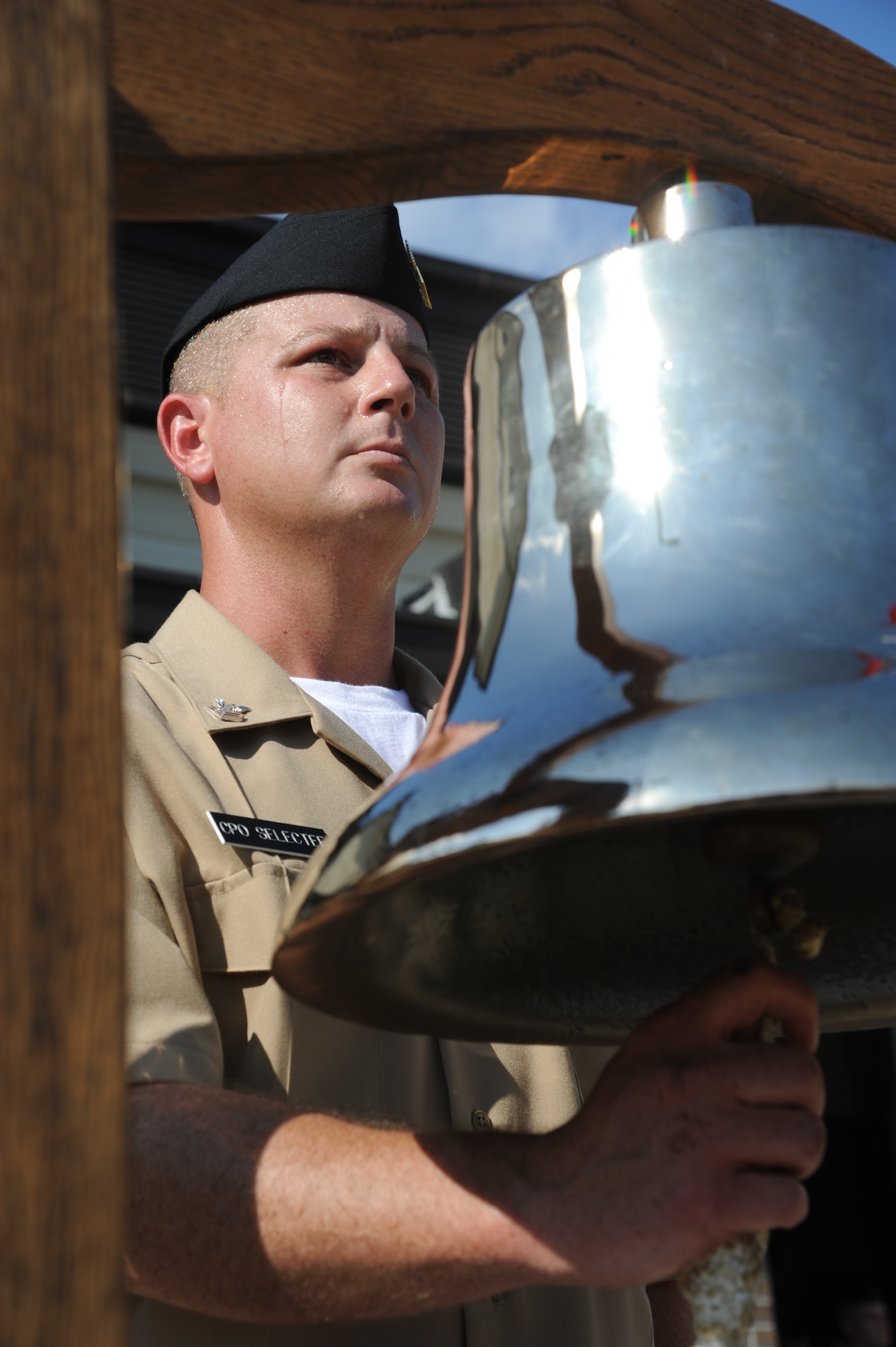 Petty Officer 1st Class Blake Henry, Center for Naval Aviation Technical Training Unit Keesler, rings a bell once for each of the seven sailors who lost their lives in the past 12 months while serving during Operation Enduring Freedom and Operation New Dawn on Sept. 11, 2013, during a ceremony to honor those who have given their lives since 9/11, Keesler Air Force Base, Miss.,.  Members of the Keesler Marine Corps Detachment were also in attendance.  (U.S. Air Force photo by Kemberly Groue)