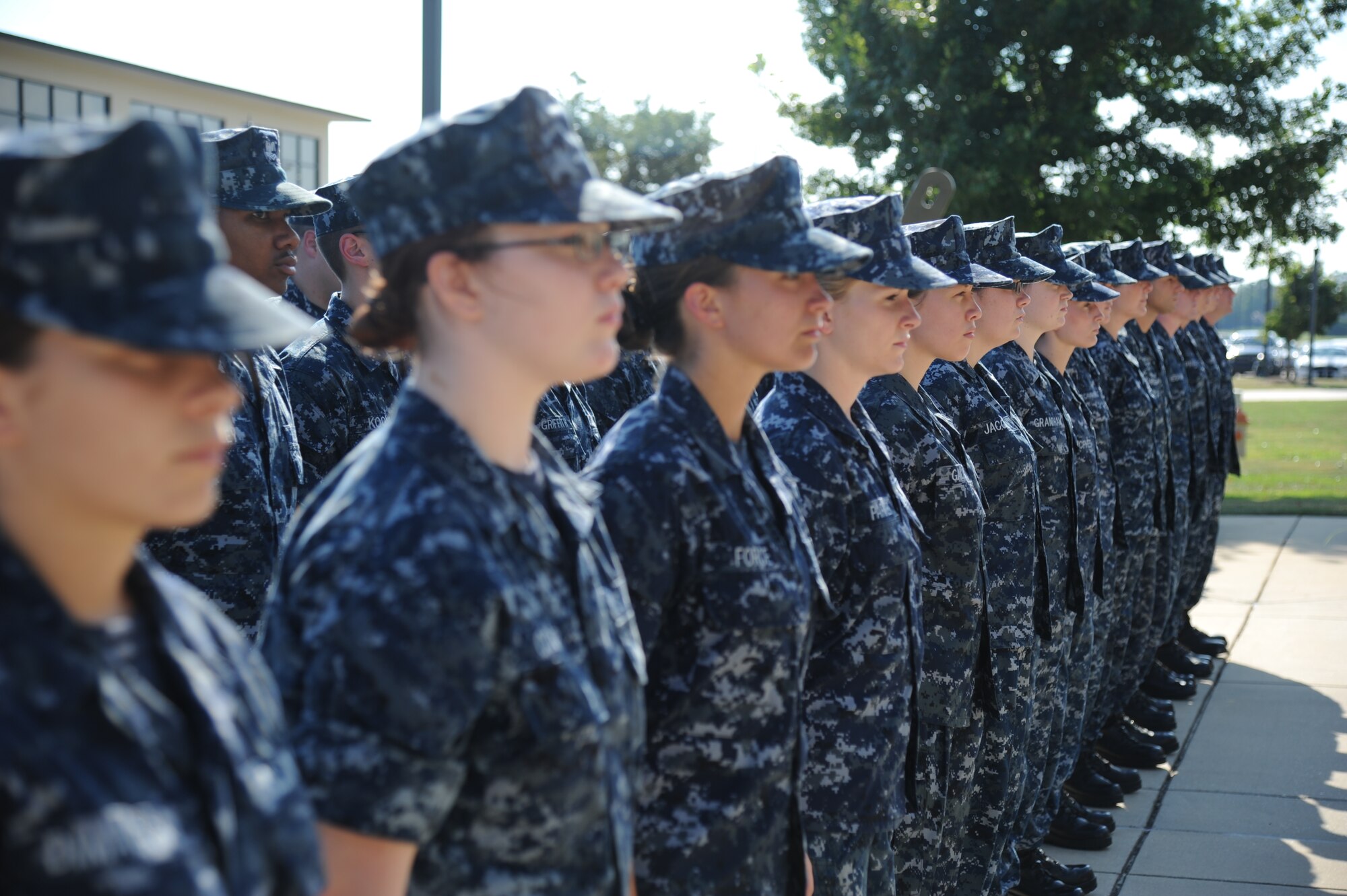Members of The Center for Naval Aviation Technical Training Unit Keesler stand at attention during a Sept. 11, 2013, Keesler Air Force Base, Miss., to honor those who have given their lives since 9/11.  (U.S. Air Force photo by Kemberly Groue)