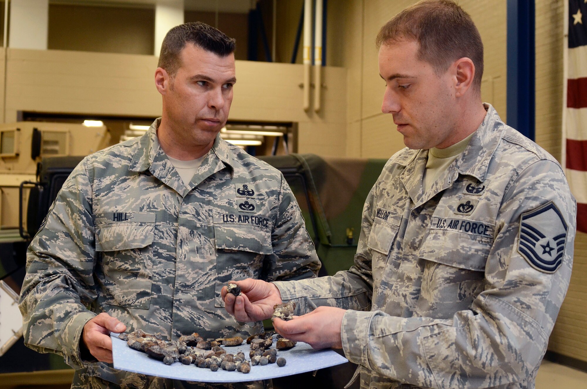 Senior Master Sgt. Matthew R. Hill, 94th Explosive Ordnance Disposal Flight superintendent and Master Sgt. Jason A. Mellor, explosive ordnance disposal examine fragments of a civil war era cannon ball Aug 2. The cannon ball was detonated and disposed of by the Dobbins EOD team after being discovered near Centennial Park, downtown Atlanta July 18. (U.S. Air Force photo/Don Peek)
