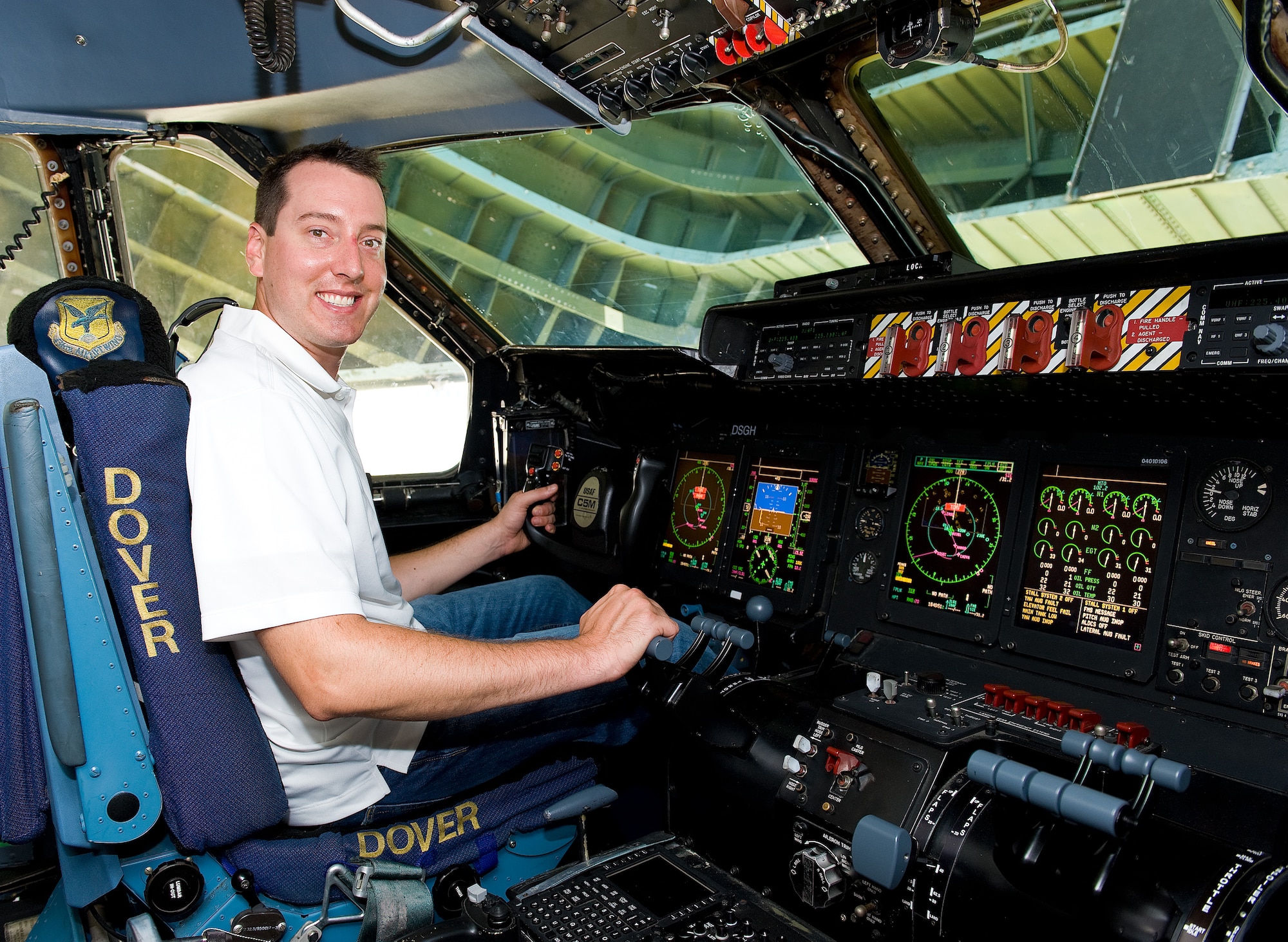 NASCAR Sprint Cup Series driver Kyle Busch sits in the cockpit of a C-5M Super Galaxy during his visit to Team Dover Sept. 11, 2013, Dover Air Force Base, Del. Busch toured the base and spoke with and signed autographs for Airmen during his visit. (U.S. Air Force photo/Roland Balik)
