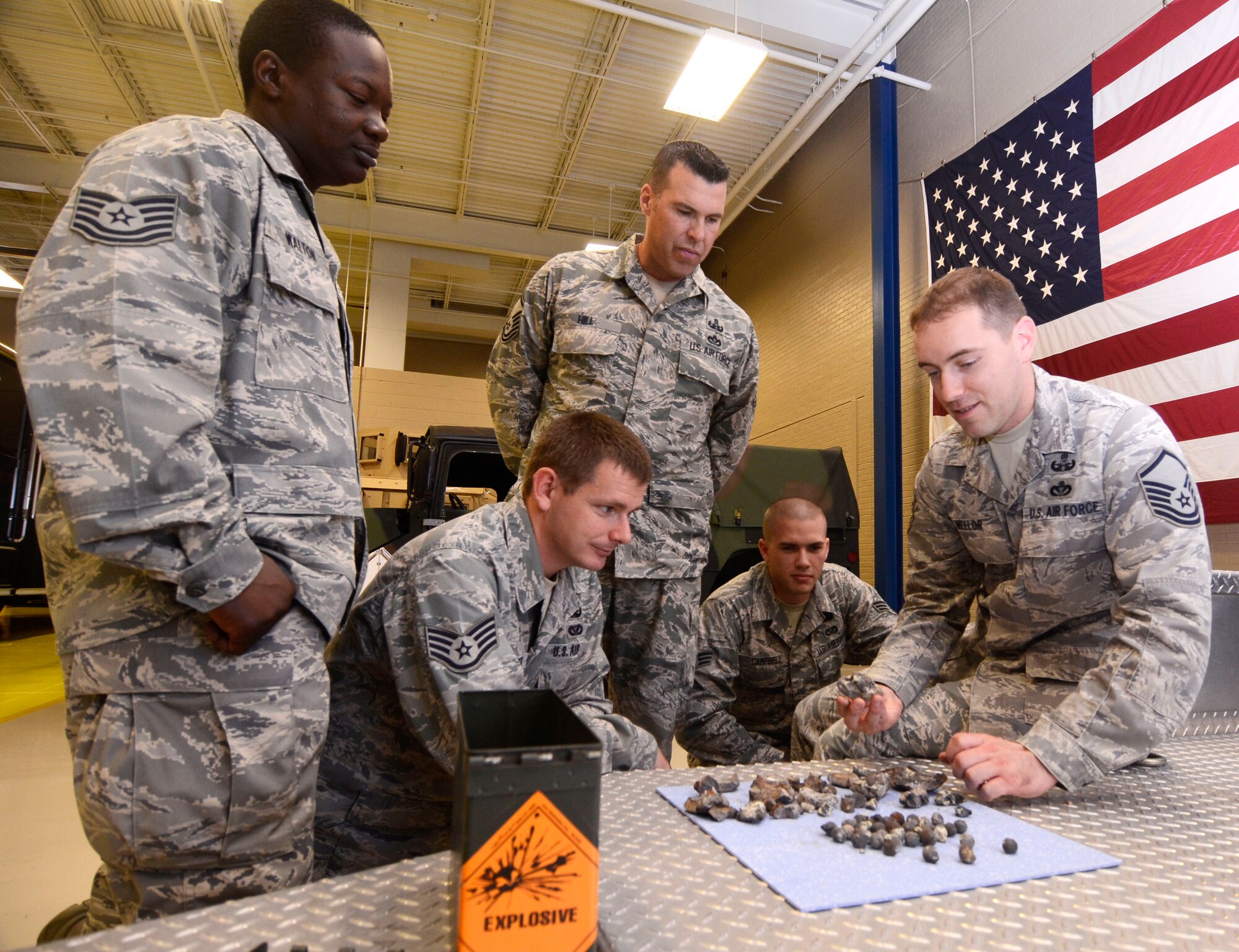 (Left to right) Tech. Sgt. George Walton, Staff Sgt. Derek Hedgespeth, Senior Master Sgt. Matthew R. Hill, Senior Airman Kyle Campbell and Master Sgt. Jason A. Mellor of 94th Explosive Ordnance Disposal, examine fragments of a civil war era cannon ball Aug 2. The cannon ball was detonated and disposed of by the Dobbins EOD team after being discovered near Centennial Park, downtown Atlanta July 18. (U.S. Air Force photo/Don Peek)