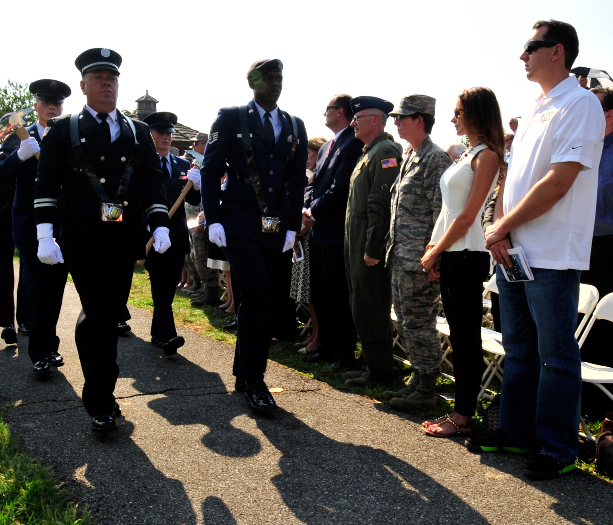 NASCAR Sprint Cup Series driver Kyle Busch watches as a color guard detail passes by during the dedication of the  Sept. 11 Memorial at the Air Mobility Command Museum, Sept. 11, 2013, Dover Air Force Base, Del. Busch started his tour of Team Dover at the ceremony. (U.S. Air Force photo/Tech. Sgt. Chuck Walker)