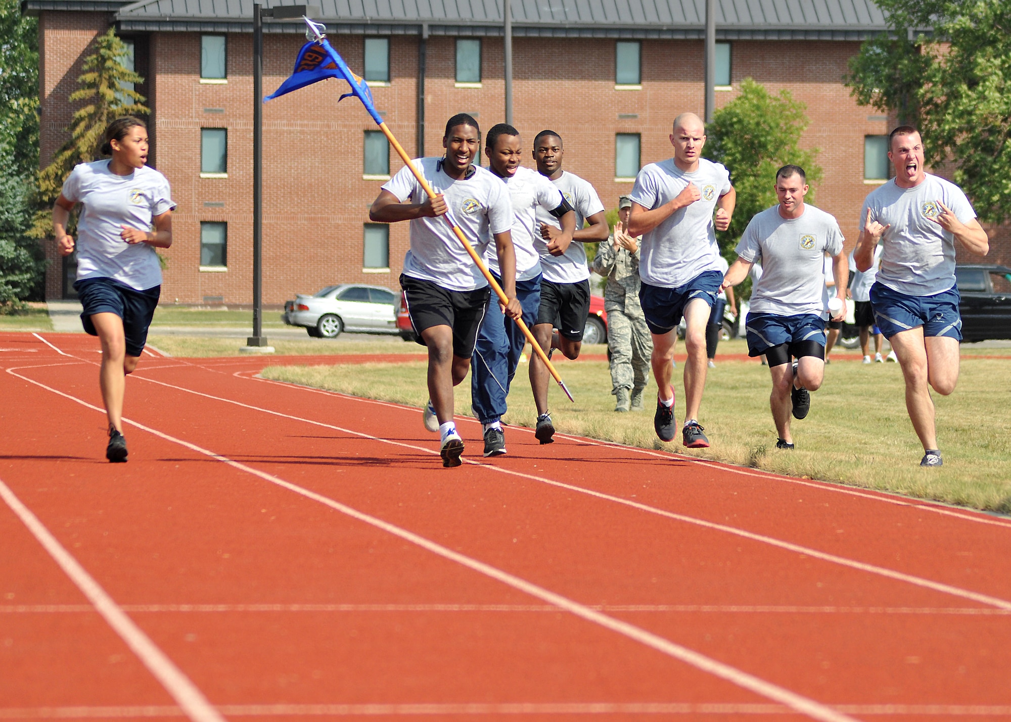 Members of the 319th Logistics Readiness Squadron run with Airman 1st Class Charles Farber, 319th Logistics Readiness Squadron, vehicle operator, on his sixth and final lap towards the finish line for his 1.5 mile run during the Triple 8 Fitness Challenge and clocked in at 8 minutes and 21 seconds at the base outdoor running track on Grand Forks Air Force Base, N.D., on Sept. 5, 2013. The Triple 8 Fitness Challenge is a premier fitness event designed to test the conditioning limits of Air Force athletes and to distinguish an elite group that sets the fitness standard. (U.S. Air Force photo/ Senior Airman Xavier Navarro)
