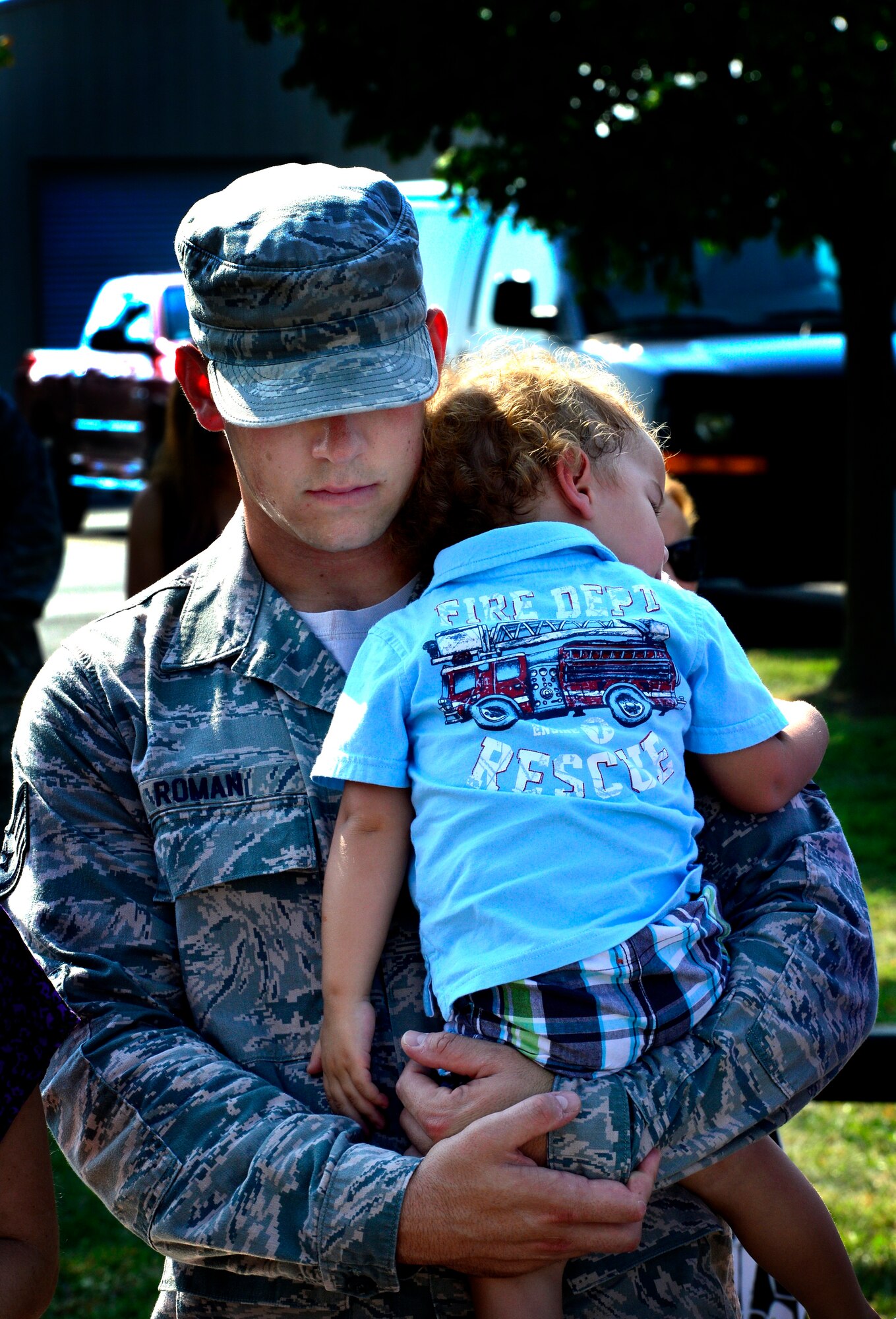 Staff Sgt. Eric Roman and his son Galen pray as the chaplain renders the invocation at the dedication of the Sept. 11 Memorial Sept. 11, 2013, at the Air Mobility Command Museum on Dover Air Force Base, Del. The memorial, which incorporates two pieces of steel from World Trade Center tower one, a rock from the United Airlines Flight 93 crash site and a block from the damaged portion of the Pentagon, was unveiled at the ceremony.  (U.S. Air Force photo/David S. Tucker)