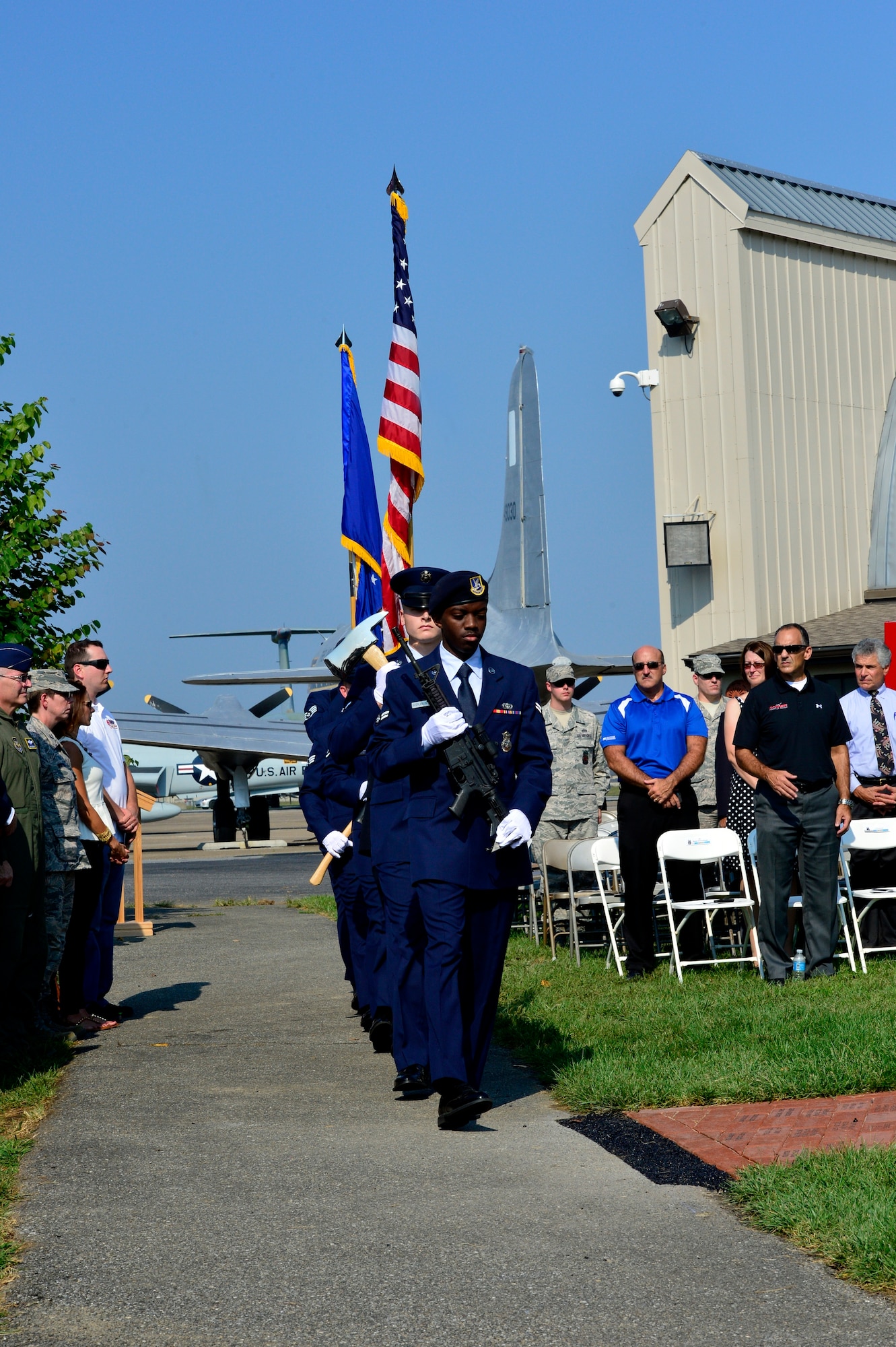 Members of the Dover Air Force Base Honor Guard march at the dedication of the Sept. 11 Memorial at the Air Mobility Command Museum, Dover Air Force Base, Del., Sept. 11, 2013. The memorial, which incorporates two pieces of steel from World Trade Center tower one, a rock from the United Airlines Flight 93 crash site and a block from the damaged portion of the Pentagon, was unveiled at the ceremony.  (U.S. Air Force photo/David S. Tucker)