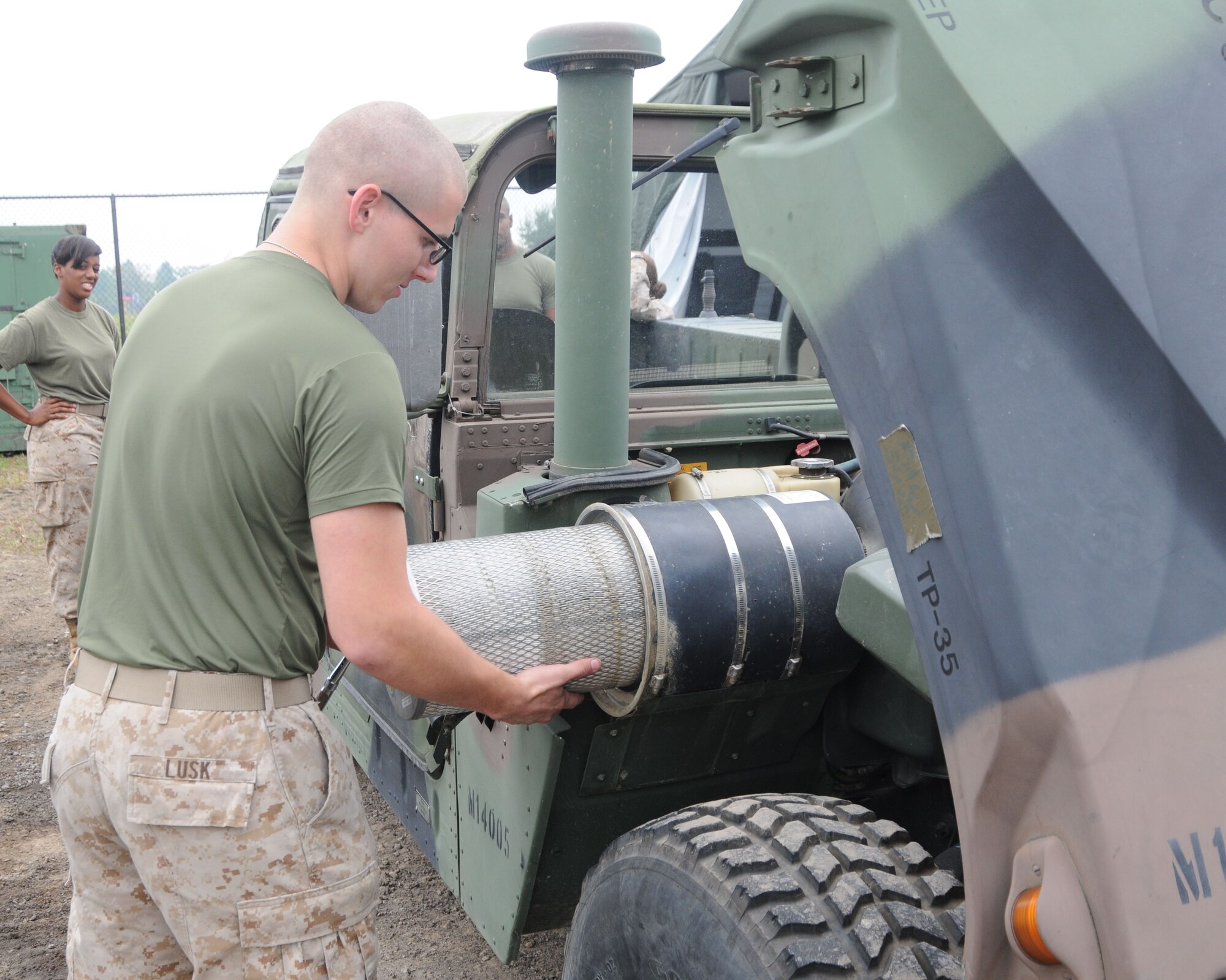 Marine Reserve Lance Cpl. Theodore Lusk, an automotive technician with  Det-3
Maintenance Company, CLB-453, conducts vehicle maintenance on a High Mobility Multi-Purpose Wheeled Vehicle (HMMWV) here Sept. 7, 2013. After more than 20 years as an engineering support unit, their mission here changed Sept. 7 to a wheeled vehicle maintenance operation. U.S. Air Force photo by Tech. Sgt. Rick Lisum
