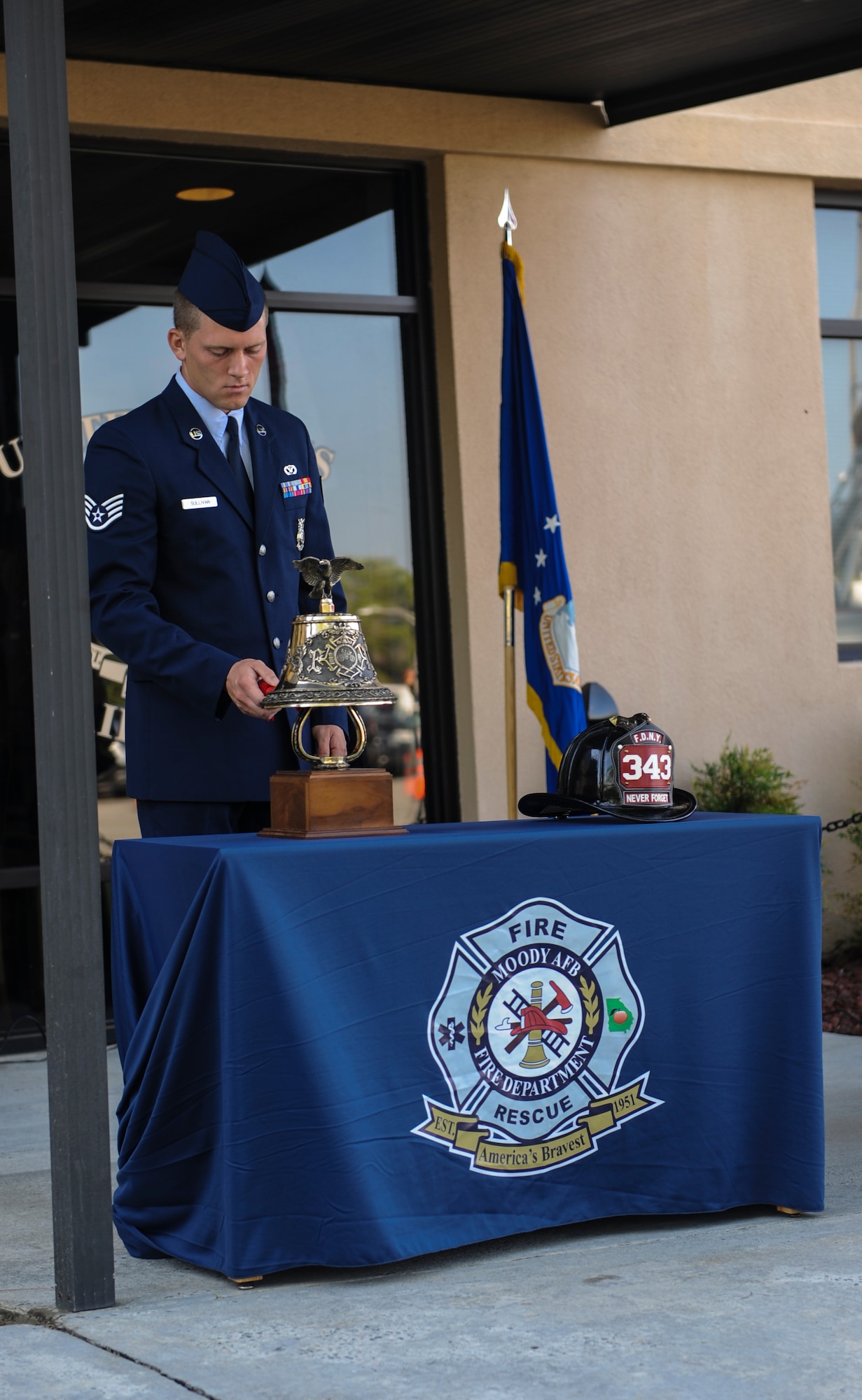 U.S. Air Force Staff Sgt. Kegan Sullivan, 23d Civil Engineer Squadron fire protection crew chief, rings a ceremonial bell for three sets of three rings at Moody Air Force Base, Ga., Sept. 11, 2013. The first set of bells represented the call to duty, the second set represented the completion of duty and the final set represented the members who are coming home. (U.S. Air Force photo by Airman Alexis Grotz/Released)
