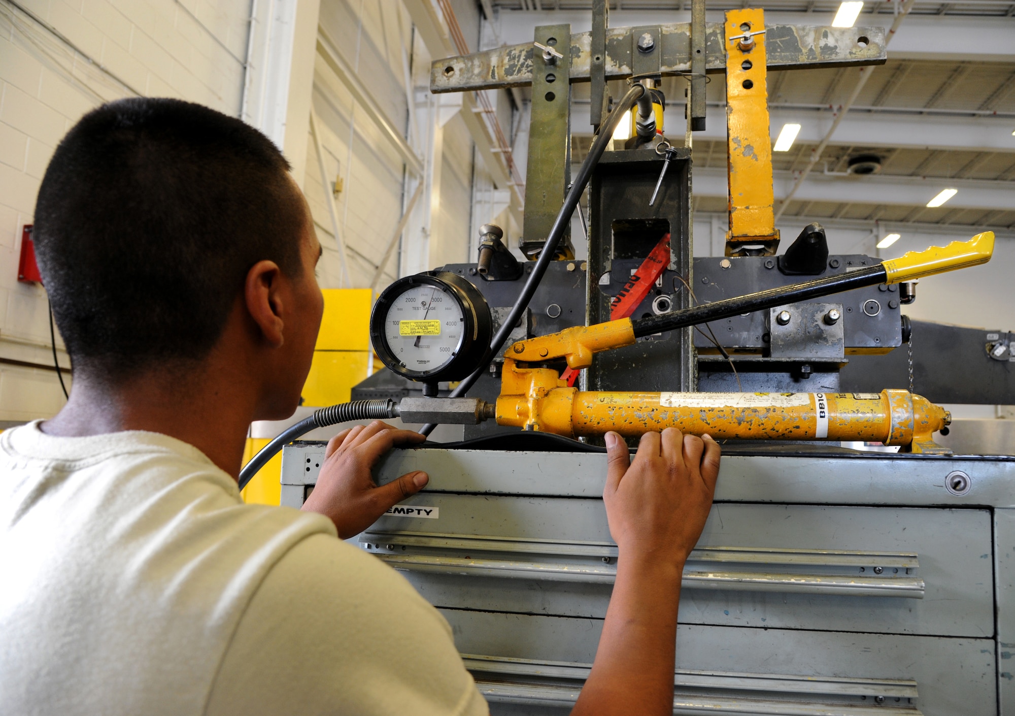 Airman 1st Class Manuel Figueroa, 2nd Munitions Squadron armament flight technician, uses a proof load tester on a MAU-12 on Barksdale Air Force Base, La., Sept. 11, 2013. Figueroa used the tester to see if the MAU-12 is working properly and capable of holding the weight of a bomb. The MAU-12 is able to withstand 2,840 pounds per square inch of pressure. (U.S. Air Force photo/Senior Airman Joseph A. Pagán Jr.)