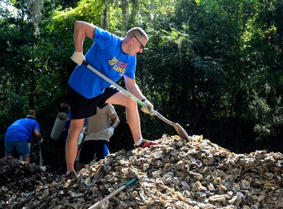 Capt. Jonathan Blount, 628th Security Forces Squadron operations officer, fills bags with recycled oyster shells Sept. 6, 2013, at the Fort Johnson Oyster Reef Center in Charleston, S.C. The South Carolina Oyster Resoration and Enhancement program uses the bags to create new oyster habitats in the local waters which in turn, improves water quality. Approximately 2,500 service members from JB Charleston participated in the Trident United Way’s Day of Caring, volunteering their skills to assist with more than 50 projects in the local community. (U.S. Air Force Photo/ 2nd Lt. Alexandra Trobe)