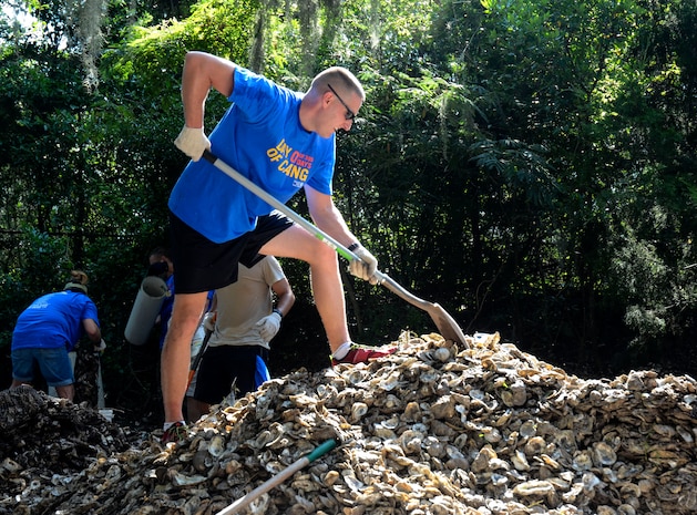 Capt. Jonathan Blount, 628th Security Forces Squadron operations officer, fills bags with recycled oyster shells Sept. 6, 2013, at the Fort Johnson Oyster Reef Center in Charleston, S.C. The South Carolina Oyster Resoration and Enhancement program uses the bags to create new oyster habitats in the local waters which in turn, improves water quality. Approximately 2,500 service members from JB Charleston participated in the Trident United Way’s Day of Caring, volunteering their skills to assist with more than 50 projects in the local community. (U.S. Air Force Photo/ 2nd Lt. Alexandra Trobe)