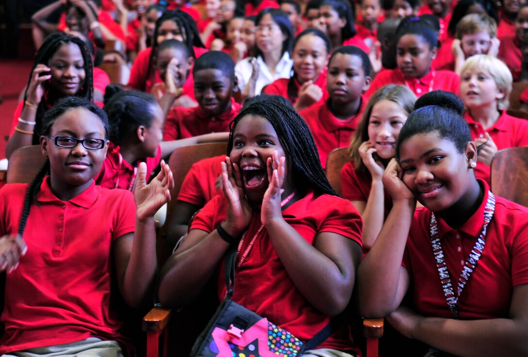 Stuart-Dobson middle school students react to the music played by the group Max Impact of the United States Air Force Band on Sept. 11, 2013 in the schools auditorium. The band members discussed the importance of the historic day with students and staff in between performances . (U.S. Air Force Photo/ Ms. Amber J. Russell)
