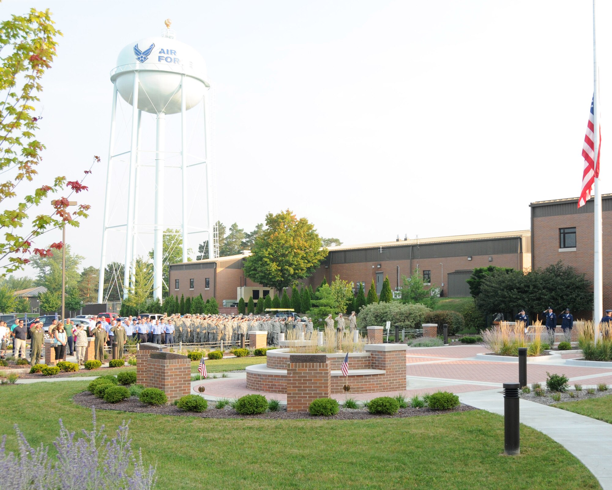 YOUNGSTOWN AIR RESERVE STATION, Ohio—YARS employees salute or stand respectfully as 910th Airlift honor guard members lower the flag to half mast during a Sept. 11th memorial ceremony, here. Youngstown Air Reserve Station employees paused during their work day to remember the tragic events of Sept. 11, 2001. U.S. Air Force photo by TSgt. Rick Lisum.