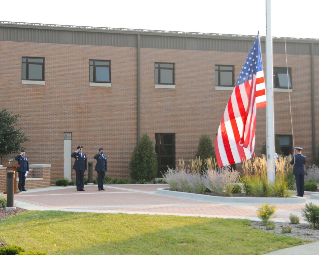 YOUNGSTOWN AIR RESERVE STATION, Ohio--Members of the 910th Airlift Wing salute as the honor guard members raise the flag to half mast during a Sept. 11th memorial ceremony, here. Youngstown Air Reserve Station employees paused during their work day to remember the tragic events of Sept. 11, 2001. U.S. Air Force photo by TSgt. Rick Lisum. 