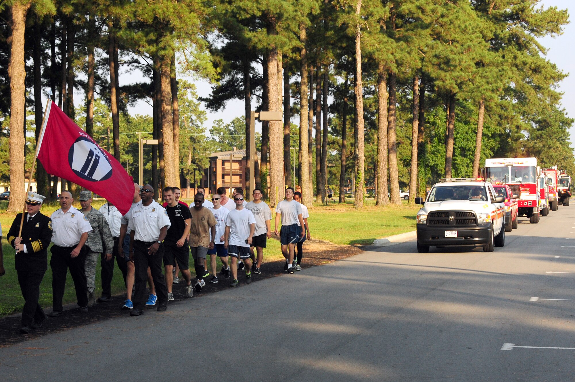 A group of Airmen led by Sean Quinby, 4th Civil Engineer Squadron fire chief, participate in a final march with the 9/11 Remembrance Flag on the two-mile track at Seymour Johnson Air Force Base, N.C., Sept. 12, 2013.  Members of the 4th CES set a goal of 343 miles, which is equivalent to the number of firefighters killed in the line-of-duty during the 9/11 attacks.  Team Seymour bested the goal by more than 1,000 miles.  (U.S. Air Force photo by Airman 1st Class Brittain Crolley)