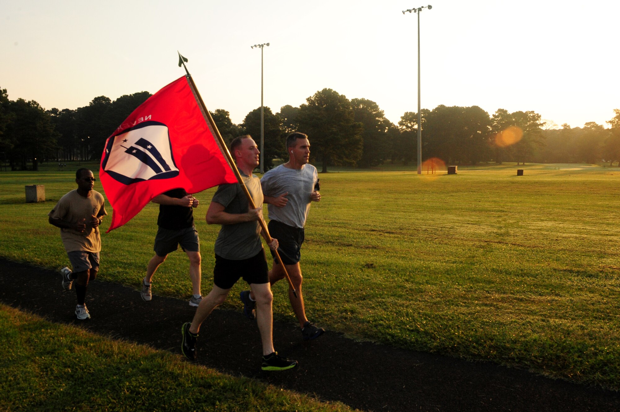 U.S. Air Force Airmen assigned to the 4th Fighter Wing run with the 9/11 Remembrance Flag during a memorial run at Seymour Johnson Air Force Base, N.C., Sept. 12, 2013.  To pay respect to the 343 fallen firefighters, the 4th Civil Engineer Squadron began the tribute run with their youngest firefighter and ended with the oldest.  (U.S. Air Force photo by Airman 1st Class Brittain Crolley)