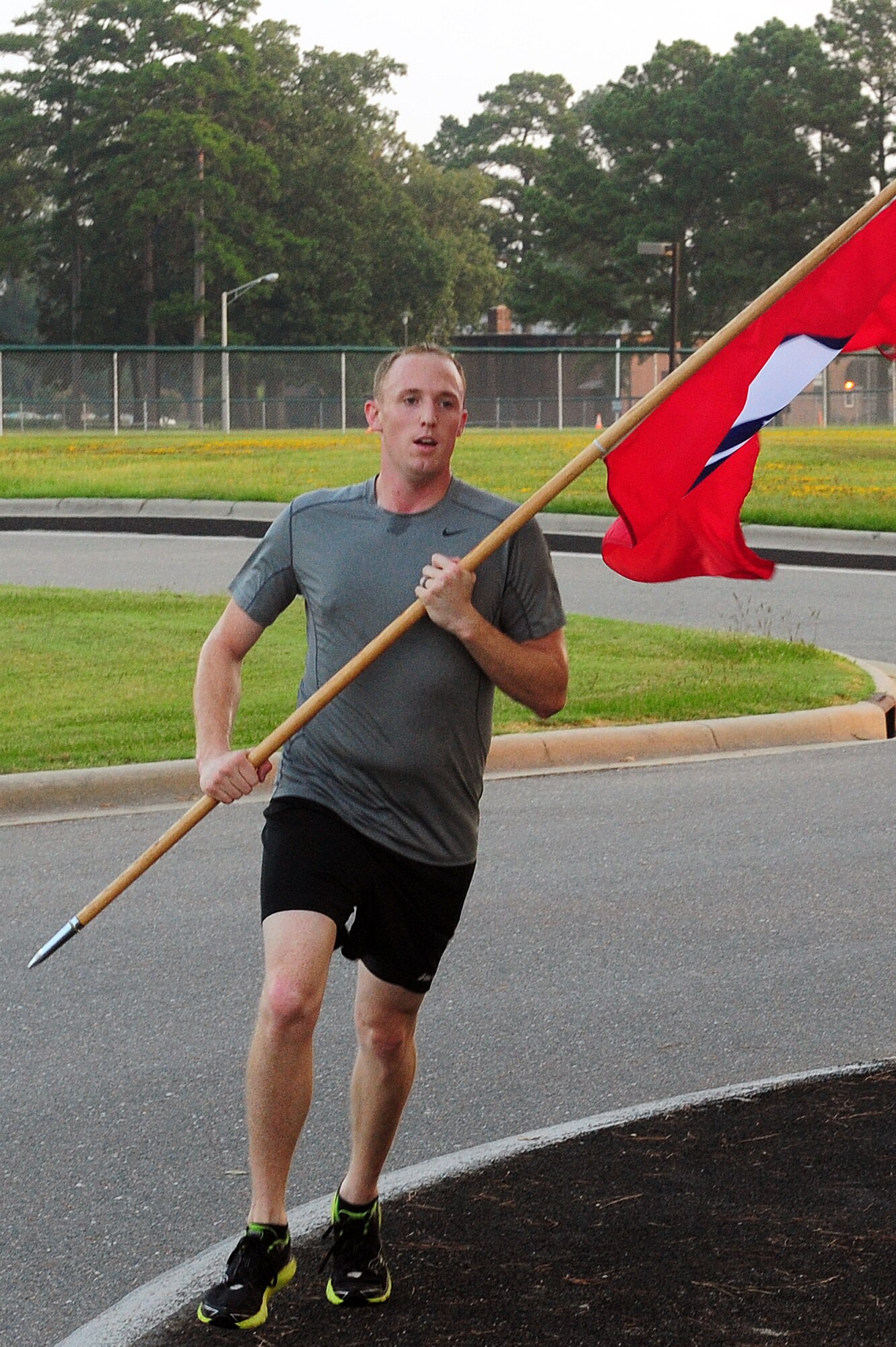 U.S. Air Force Staff Sgt. Bryan Griswold, 4th Operations Support Squadron air traffic controller, carries the 9/11 Remembrance Flag during a memorial run at Seymour Johnson Air Force Base, N.C., Sept. 12, 2013.  Members of Team Seymour ran for 24 hours, dedicating 1,409 miles in total, to honor those who lost their lives during the 9/11 attacks.  (U.S. Air Force photo by Airman 1st Class Brittain Crolley) 