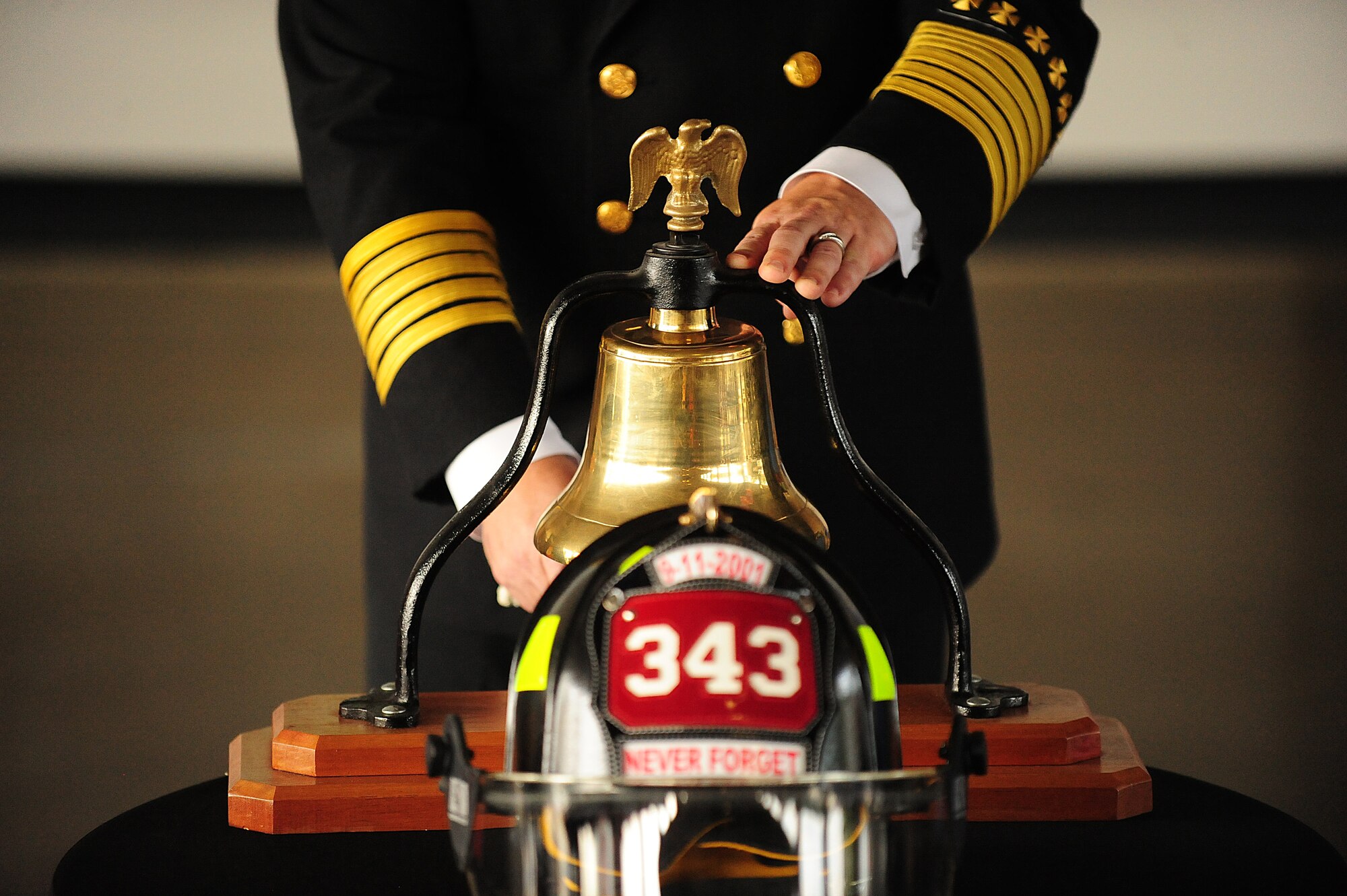Sean Quinby, 4th Civil Engineer Squadron fire chief, rings a bell in honor of fallen first-responders during a 9/11 memorial ceremony at Seymour Johnson Air Force Base, N.C., Sept. 11, 2013.  The bell ceremony symbolizes the alarm used to announce the end of a call and represents a fallen comrade who has completed their duty.  (U.S. Air Force photo by Airman 1st Class Brittain Crolley)