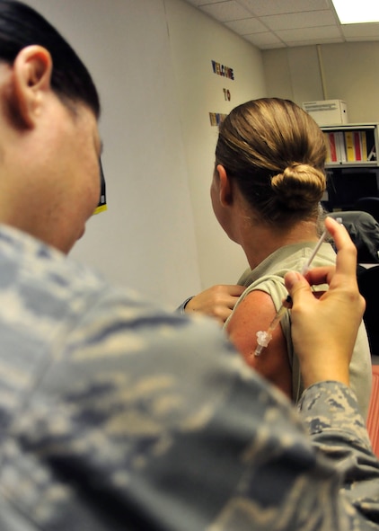 Air Force Reserve Capt.  Lisa Haik, from the 919th Medical Squadron, provides a vaccine to a fellow reservist at Duke Field, Fla., Sept 7.  Base personnel received their annual vaccinations during the unit training assembly.  (U.S. Air Force photo/Tech. Sgt. Jasmin Taylor)