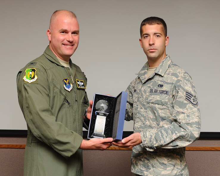 Col. Jeff Neischel, 5th Bomb Wing vice commander, presents Staff Sgt. Kent Bode, 5th Aircraft Maintenance Squadron crew chief, with the Air Force Global Strike Command 2013 Federal Asian Pacific American Council Military Meritorious Service Award here, Sept. 4. Bode is a Dedicated Crew Chief on a B-52H Stratofortress and received the award in recognition of his support of activities on-base, and in the local community, while deployed to Anderson Air Force Base, Guam. (U.S. Air Force photo/Senior Airman Stephanie Sauberan)