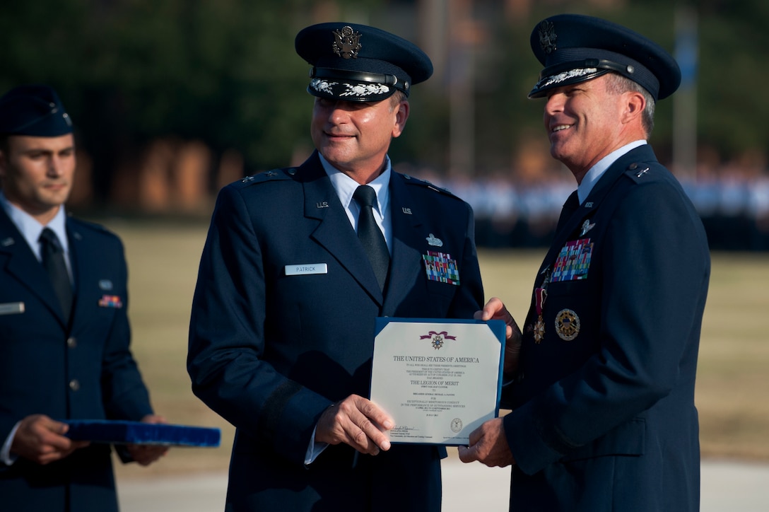 Maj. Gen. Leonard Patrick, 2nd Air Force commander, presents the Legion of Merit to Brig. Gen. Michael Fantini at the 82nd Training Wing change of command ceremony Sept. 12, 2013. Brig. Gen. Scott Kindsvater took command of the largest technical training base from Fantini. Patrick presided over the ceremony. (U.S. Air Force photo/Staff Sgt. Mike Meares)
