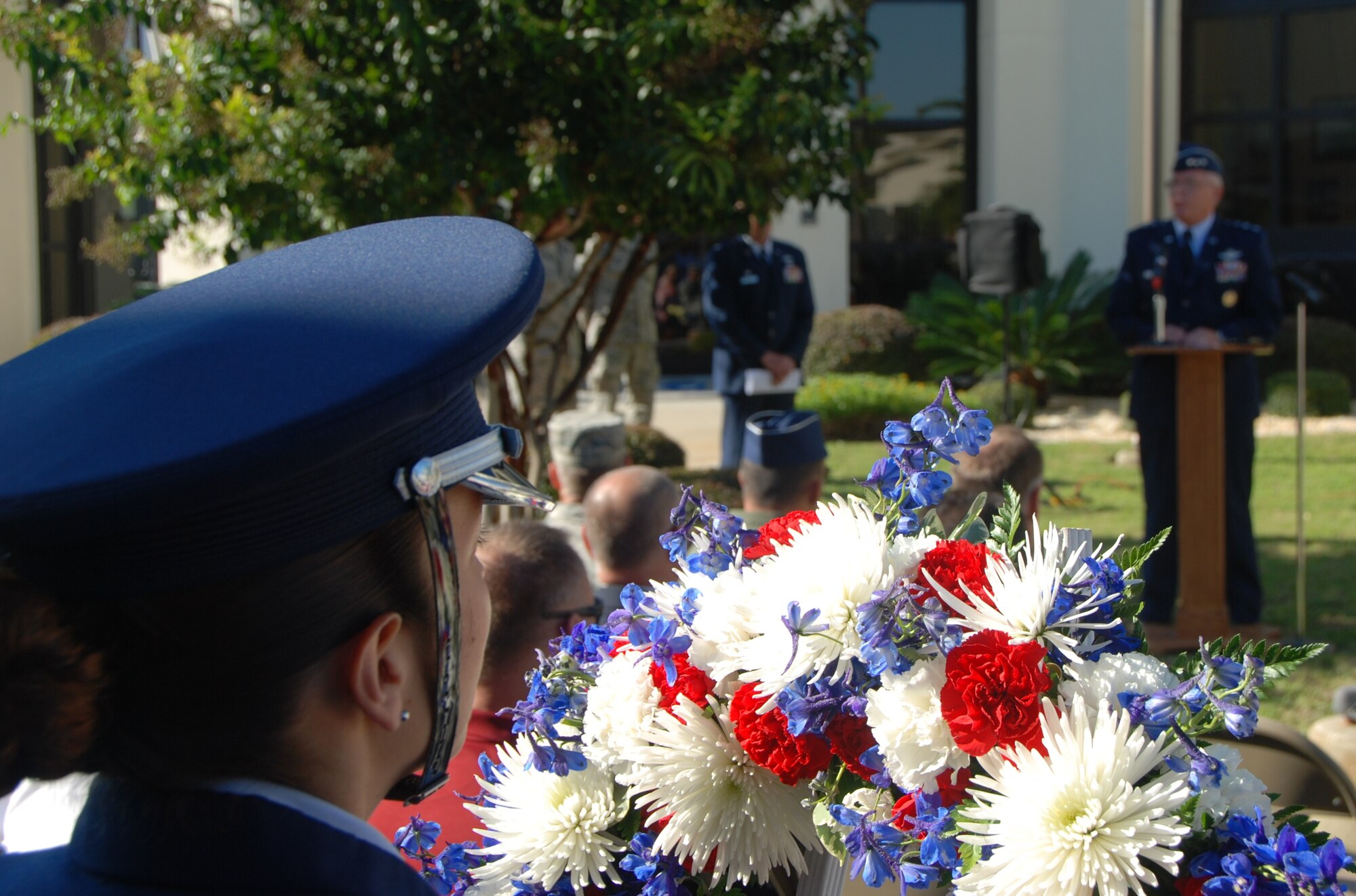 U.S. Air Force Staff Sgt. Karla Rodriguez, a member of the 601st Air and Space Operations Center Color Guard, looks on as U.S. Air Force Lt. Gen. William Etter, Continental U.S. North American Aerospace Defense Command Region-1st Air Force (Air Forces Northern) commander, addresses his command during a memorial service Sept. 11, 2013, in front of the 601st AOC at Tyndall Air Force Base, Fla. The 601st AOC held a ceremony to honor the memory of those who lost their lives during the tragic events of Sept. 11, 2001. (Air National Guard photo by Capt. Jared Scott/Released)
 

