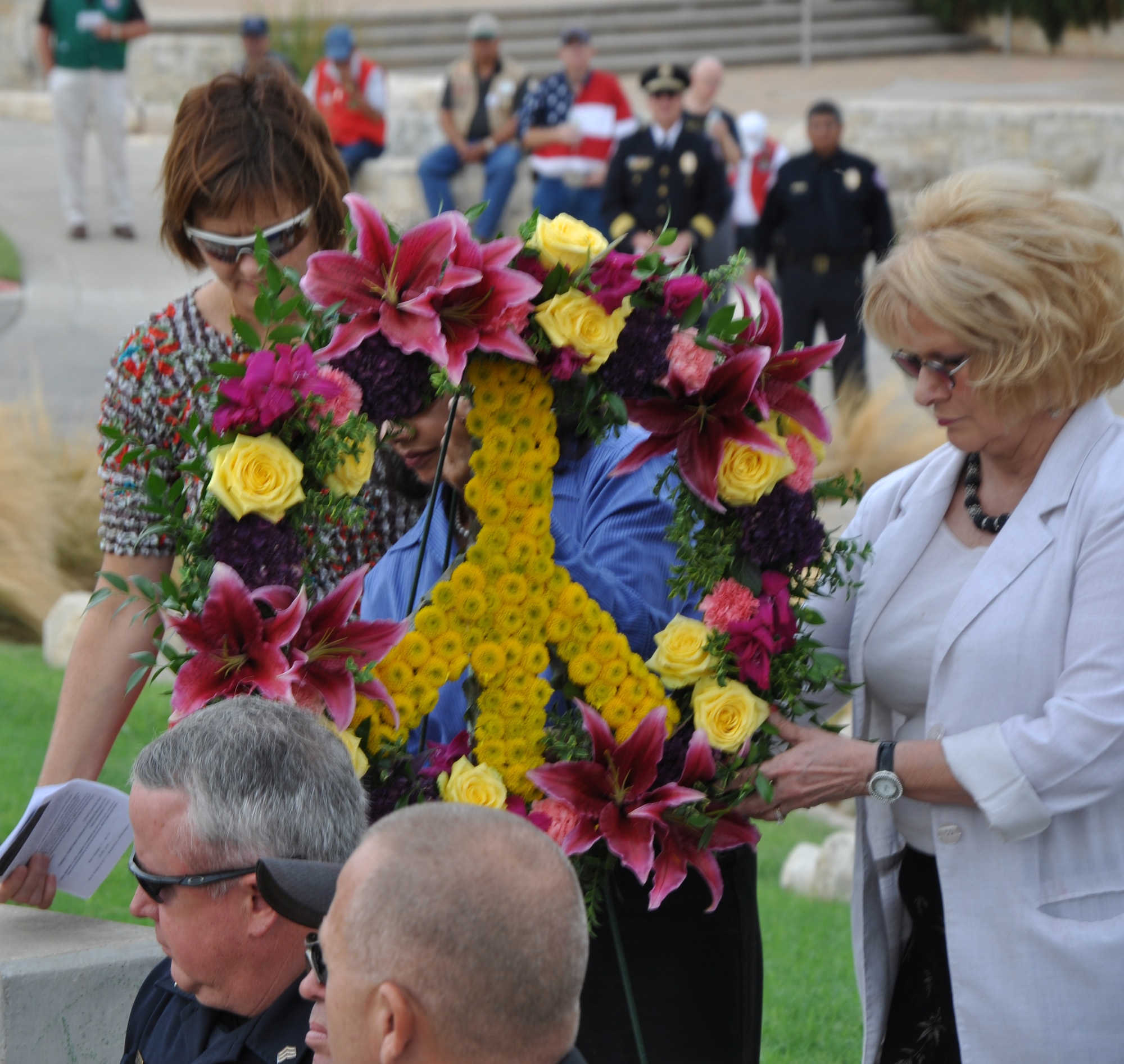SAN ANGELO, Texas – Peace Ambassadors of West Texas carry the peace wreath to the center of the San Angelo 9/11 memorial Sept. 11. During the placing of the wreath, everyone in attendance paused for a moment of silence. (U.S. Air Force photo/ Airman 1st Class Joshua Edwards)
