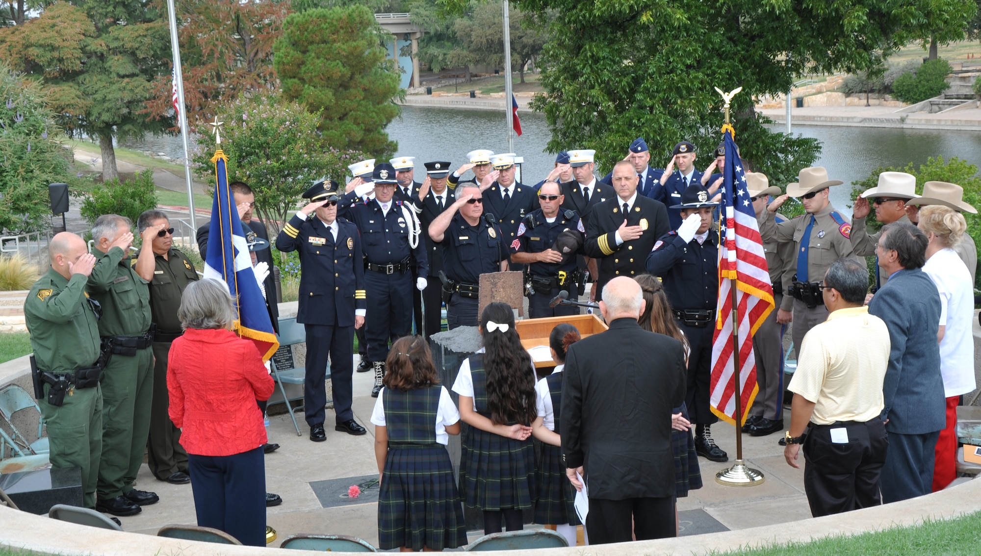 SAN ANGELO, Texas - Members from the San Angelo Police Department, Fire Department, Goodfellow and the local community salute during the Pledge of Allegiance at the San Angelo 9/11 memorial Sept. 11. After the Pledge of Allegiance, several Angelo Catholic School students read exerts from the bible. (U.S. Air Force photo/ Airman 1st Class Joshua Edwards)