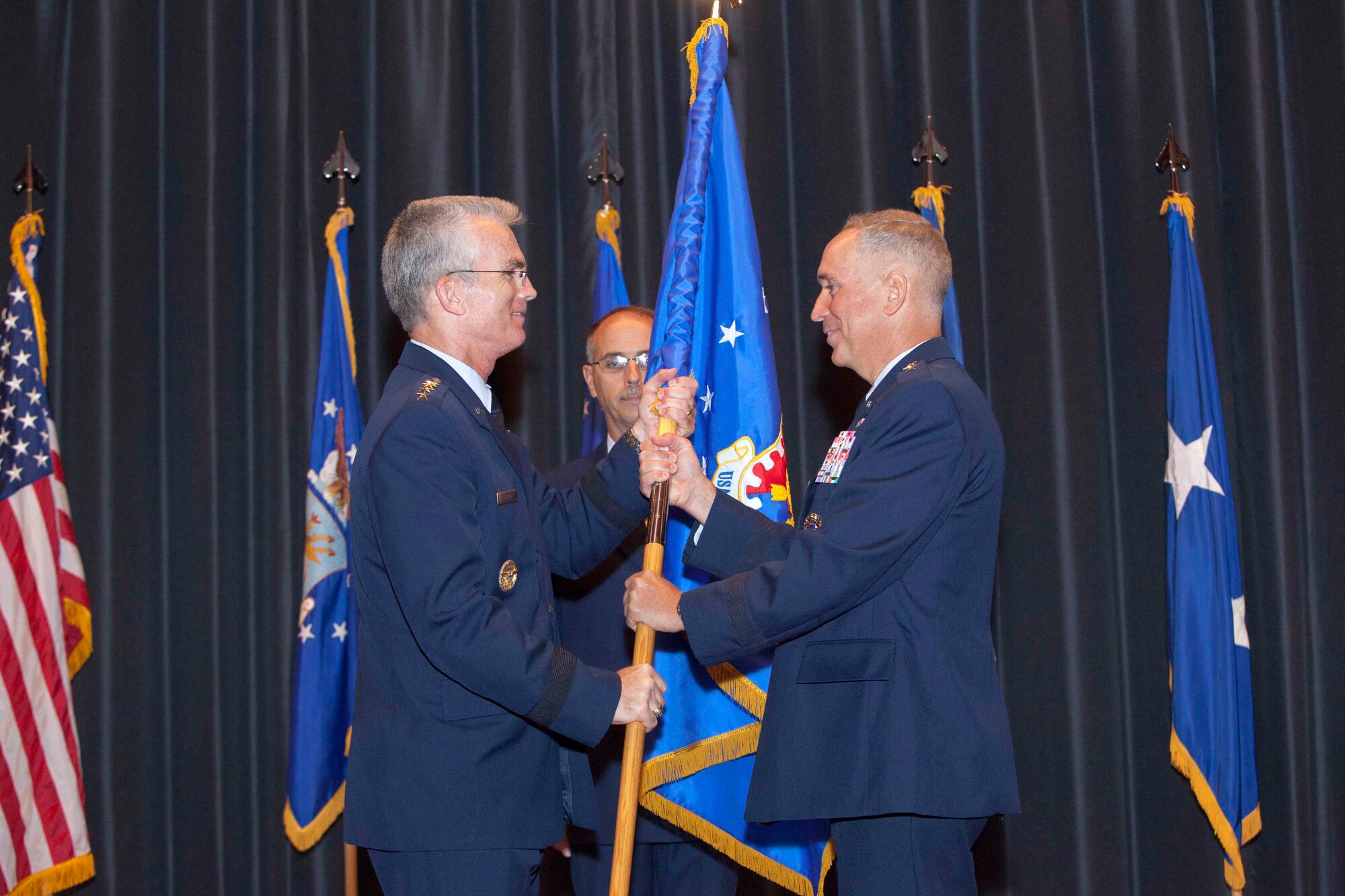 Maj. Gen. Frederick H. “Rick” Martin accepts the guide on and assumes command of the U.S. Air Force Expeditionary Center from the presiding official General Paul J. Selva, Air Mobility Command commander, during the Assumption of Command ceremony Sept. 9, 2013 on Joint Base McGuire-Dix-Lakehurst, N.J. The Expeditionary Center provides operational control of the Mobility Operations School and the Expeditionary Operations School, and administrative control for six wings and two groups within AMC, two of which are the 87th Air Base Wing and the 621st Contingency Response Wing at JB MDL. (U.S. Air Force photo by Wayne Russell/Released)