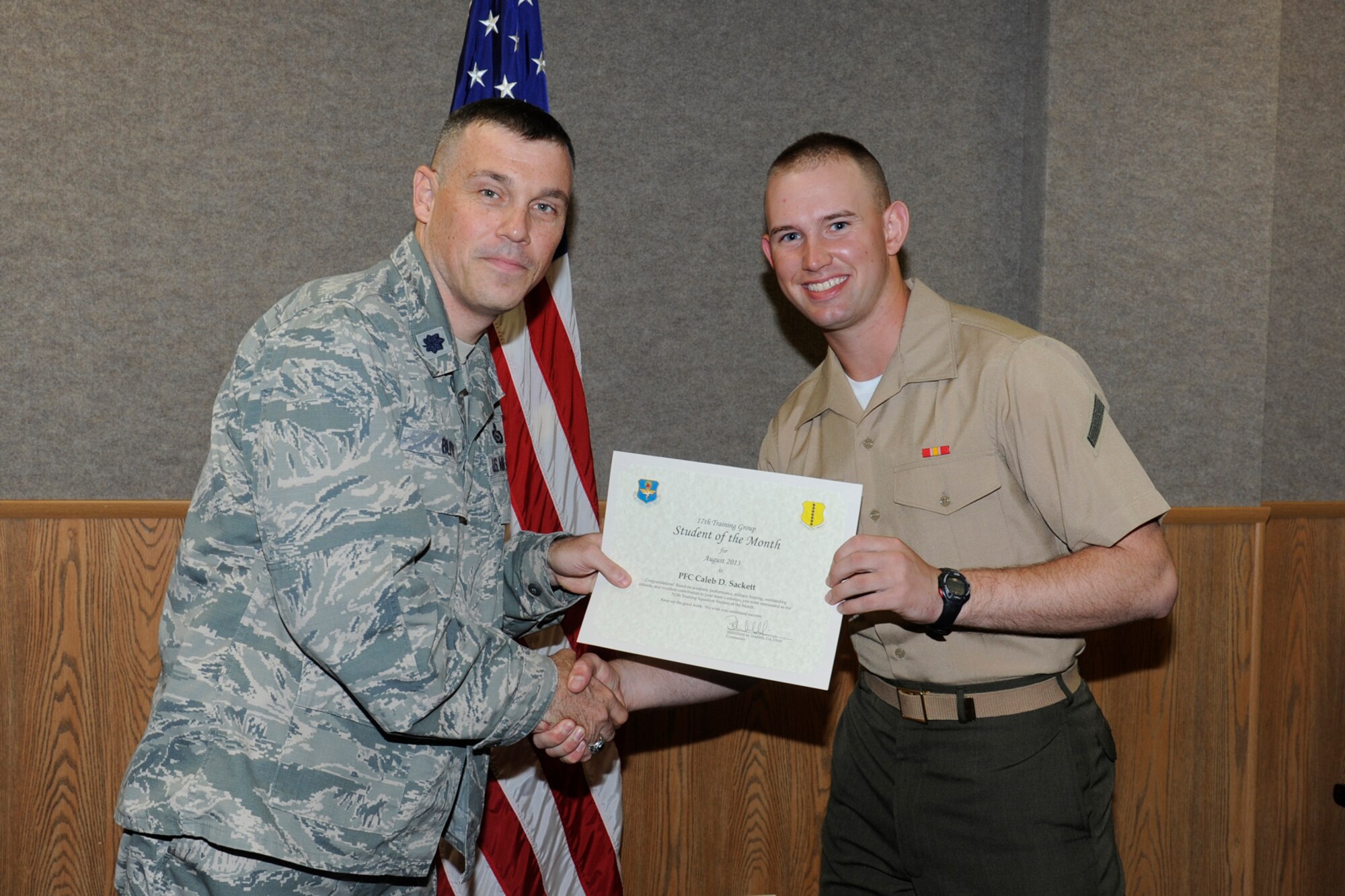 GOODFELLOW AIR FORCE BASE, Texas -- Lt. Col. Edward Blitt, 17th Training Group deputy commander, presents the August 312th Training Squadron Student of the Month award to Army Pfc. Caleb Sackett, Sept. 6. (U.S. Air Force photo by Staff Sgt. Austin Knox)