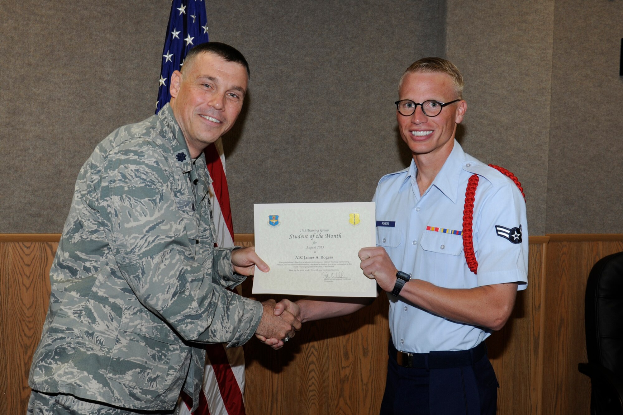 GOODFELLOW AIR FORCE BASE, Texas -- Lt. Col. Edward Blitt, 17th Training Group deputy commander, presents the August 315th Training Squadron Enlisted Student of the Month award to Airman 1st Class James Rogers, Sept. 6. (U.S. Air Force photo by Staff Sgt. Austin Knox)