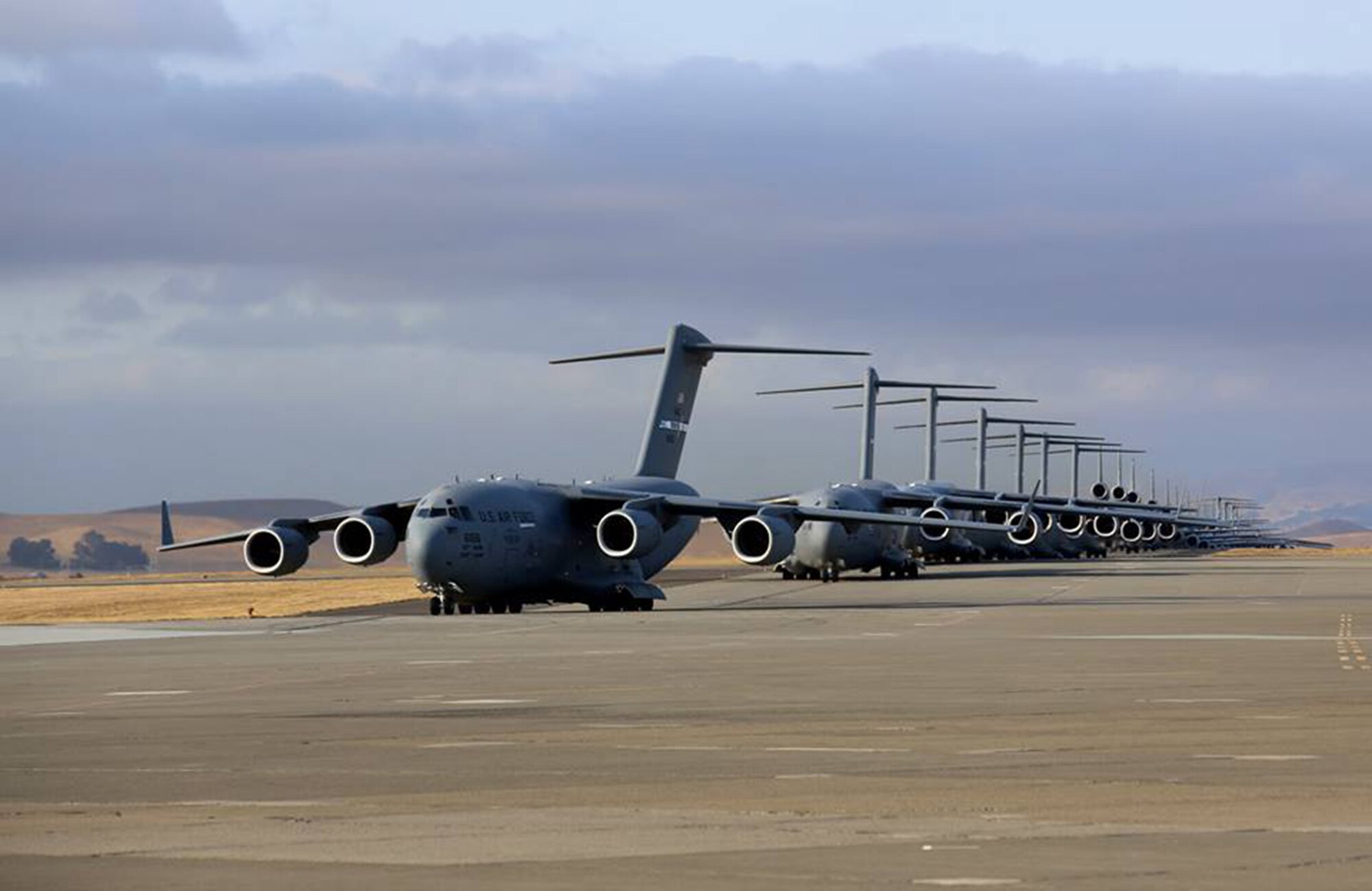 TRAVIS AIR FORCE BASE, Calif. -- Travis Air Force Base Airmen conduct a mass launch of 22 mobility aircraft Sept. 11, 2013, practicing the combat capability of safely launching a fleet of aircraft in minutes. The launch of seven C-17 Globemaster IIIs, 11 KC-10A Extenders and four C-5 Galaxies in 36 minutes, 21 seconds provided essential training for personnel. (U.S. Air Force photo/Lt. Col. Robert Couse-Baker)