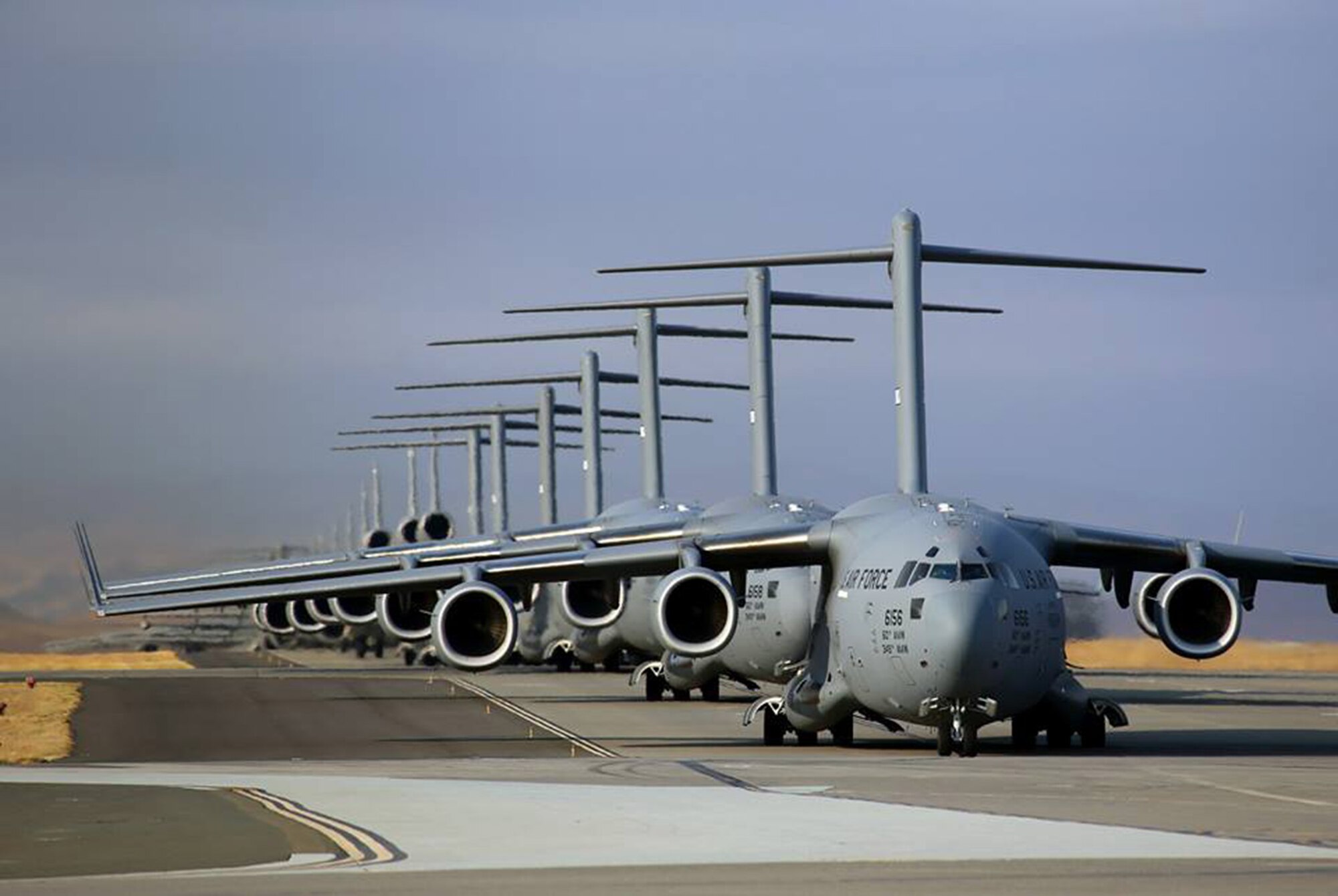 TRAVIS AIR FORCE BASE, Calif. -- Travis Air Force Base Airmen conduct a mass launch of 22 mobility aircraft Sept. 11, 2013, practicing the combat capability of safely launching a fleet of aircraft in minutes. The launch of seven C-17 Globemaster IIIs, 11 KC-10A Extenders and four C-5 Galaxies in 36 minutes, 21 seconds provided essential training for personnel. (U.S. Air Force photo/Lt. Col. Robert Couse-Baker)