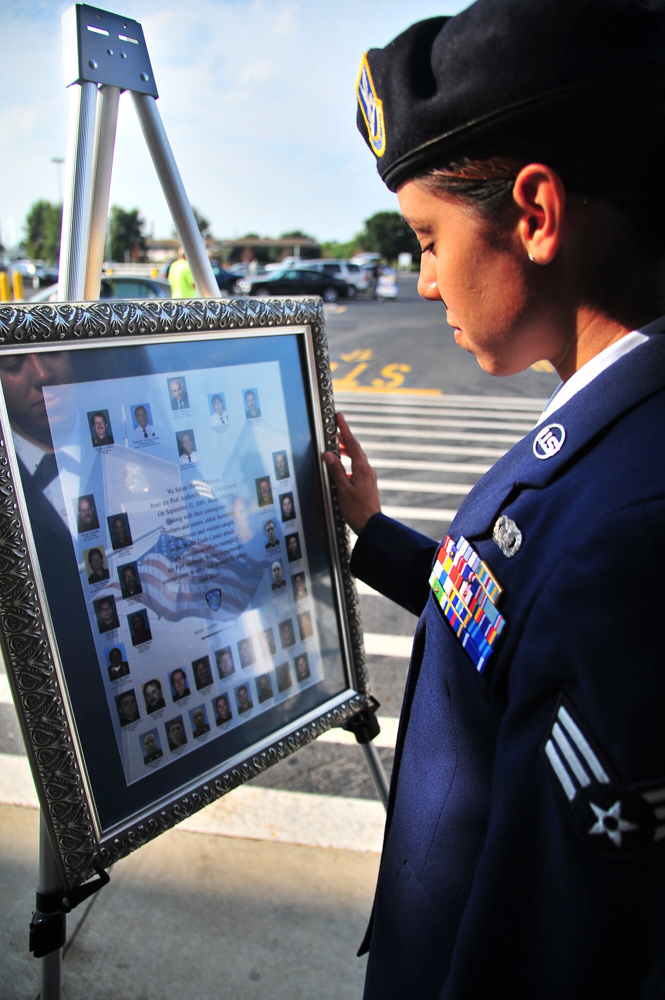 U.S. Air Force Senior Airman Marcia Montoya, 4th Security Forces Squadron defender, looks at a commemorative display during a 9/11 memorial ceremony in Goldsboro, N.C., Sept. 11, 2013. The display honored 37 local law enforcement officers who aided victims trapped in the World Trade Center during the 9/11 attacks. (U.S. Air Force photo by Senior Airman Aubrey White)
