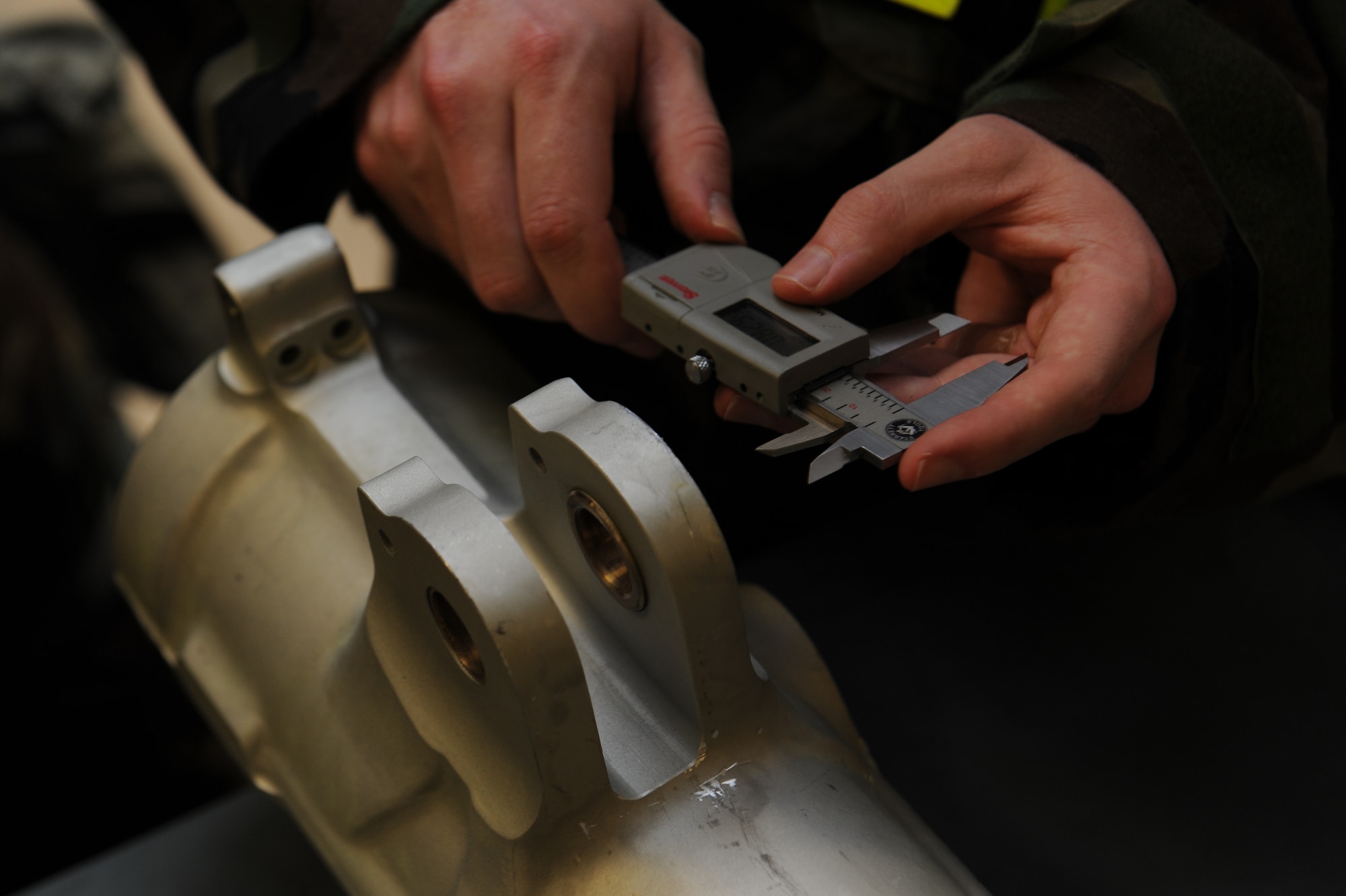 U.S. Air Force Airman 1st Class Scott Garrett, 18th Component Maintenance Squadron aircraft hydraulics journeymen, measures the bearings of an upper cylinder for an F-15 Eagle nose landing gear strut during a local operational readiness exercise on Kadena Air Base, Japan, Sept. 12, 2013. 18th CMS maintains the only four-bay engine test cell facility in Pacific Air Forces and is responsible for test measurement and diagnostic equipment services to the wing and associate units. (U.S. Air Force photo by Senior Airman Malia Jenkins)