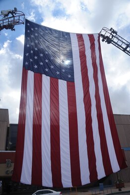 A giant flag is raised outside City Hall Plaza at a 9/11 Remembrance Ceremony Sept. 11.  (Photo by Todd Berenger)