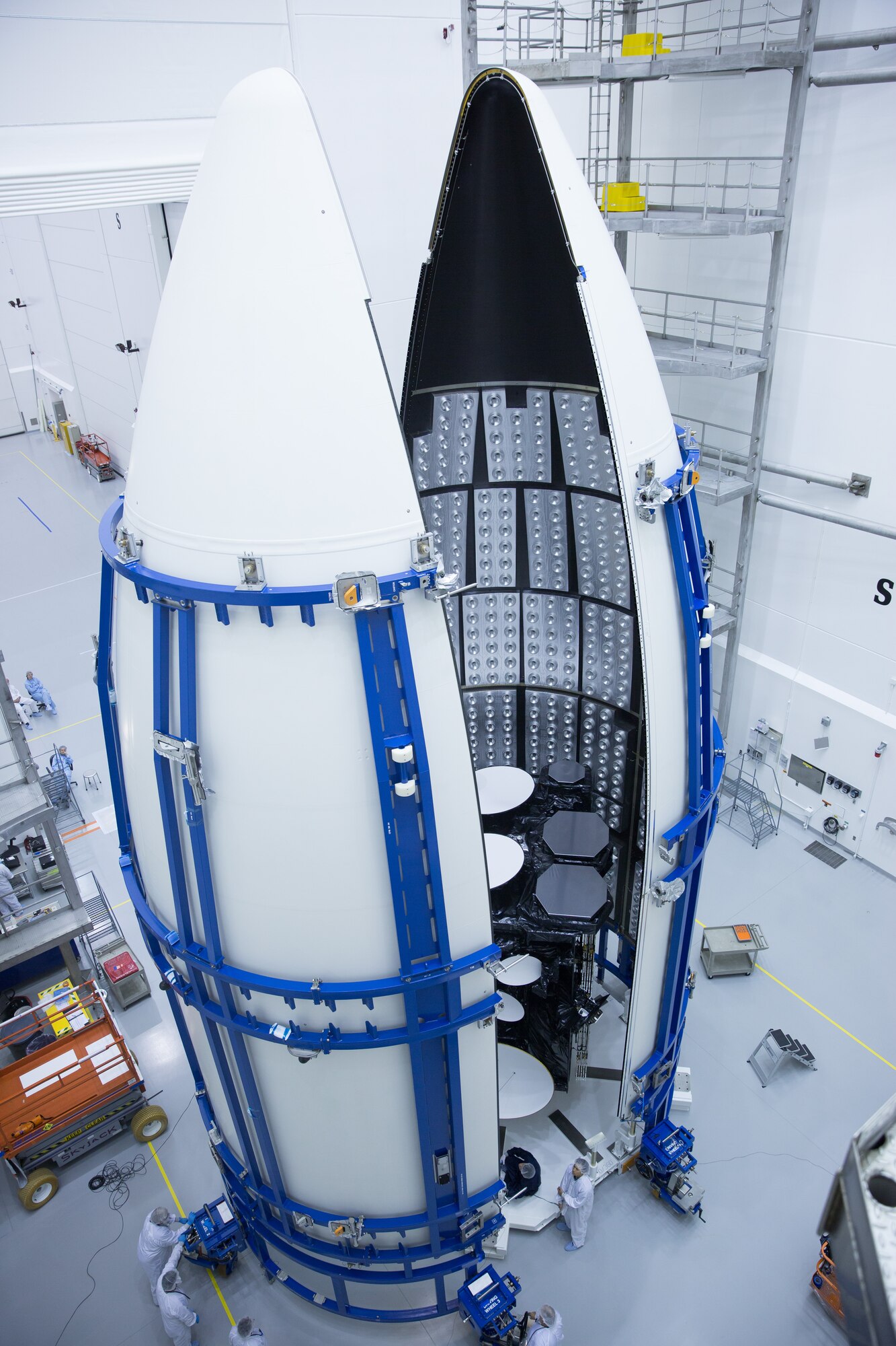Workers prepare the U.S. Air Force's third Advanced Extremely High Frequency satellite for launch near Cape Canaveral Air Force Station, Fla. The space vehicle was encapsulated into its fairing Aug. 27, 2013, before being mated to an Atlas V rocket. It is scheduled to launch on Sept. 18, 2013.  AEHF is a Joint-service system that provides survivable, near world-wide, secure, protected, and jam-resistant communications for high-priority National military operations. (Photo courtesy of Lockheed Martin)
