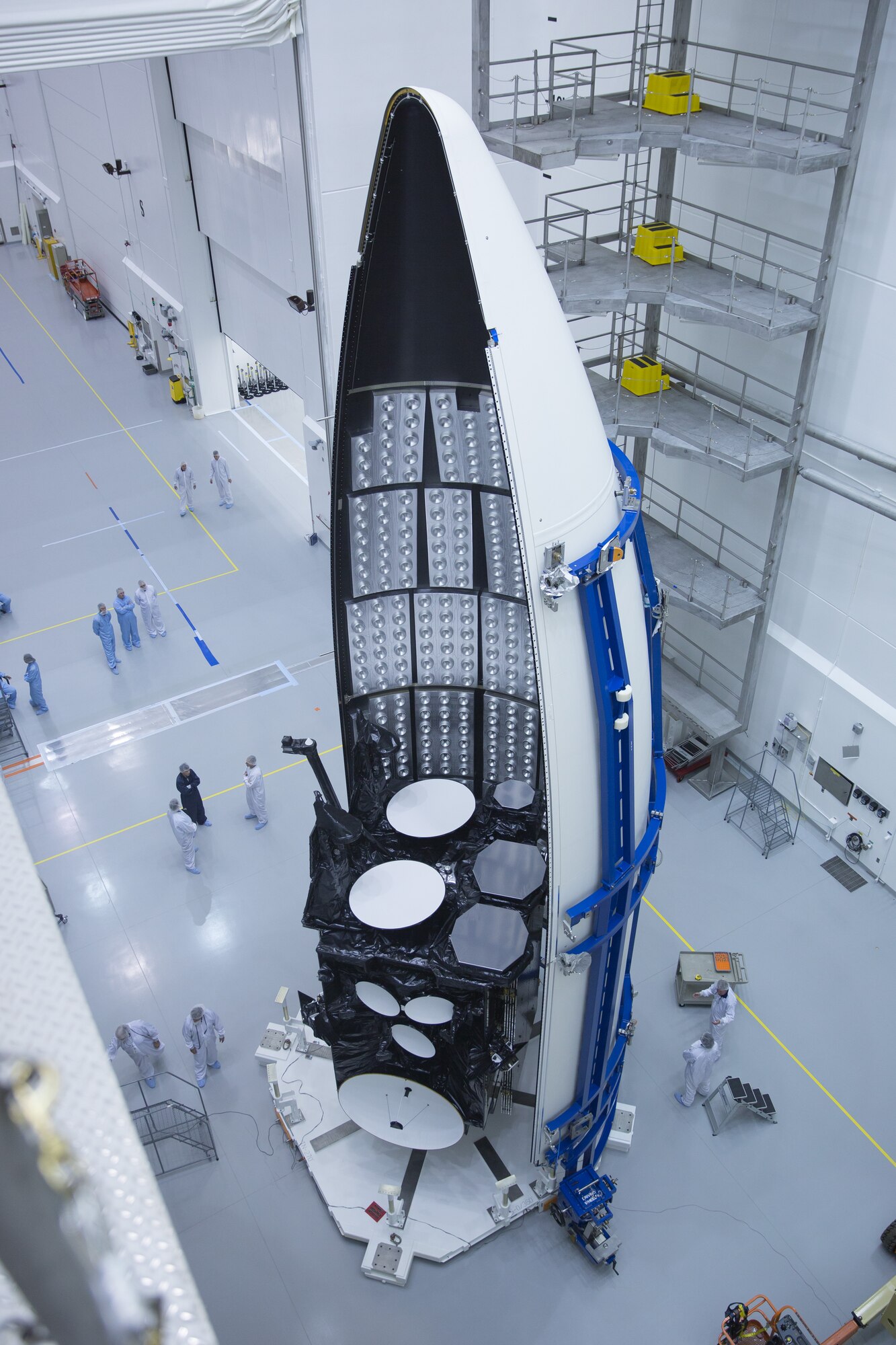 Workers prepare the U.S. Air Force's third Advanced Extremely High Frequency satellite for launch near Cape Canaveral Air Force Station, Fla. The space vehicle was encapsulated into its fairing Aug. 27, 2013, before being mated to an Atlas V rocket. It is scheduled to launch on Sept. 18, 2013.  AEHF is a Joint-service system that provides survivable, near world-wide, secure, protected, and jam-resistant communications for high-priority National military operations. (Photo courtesy of Lockheed Martin)
