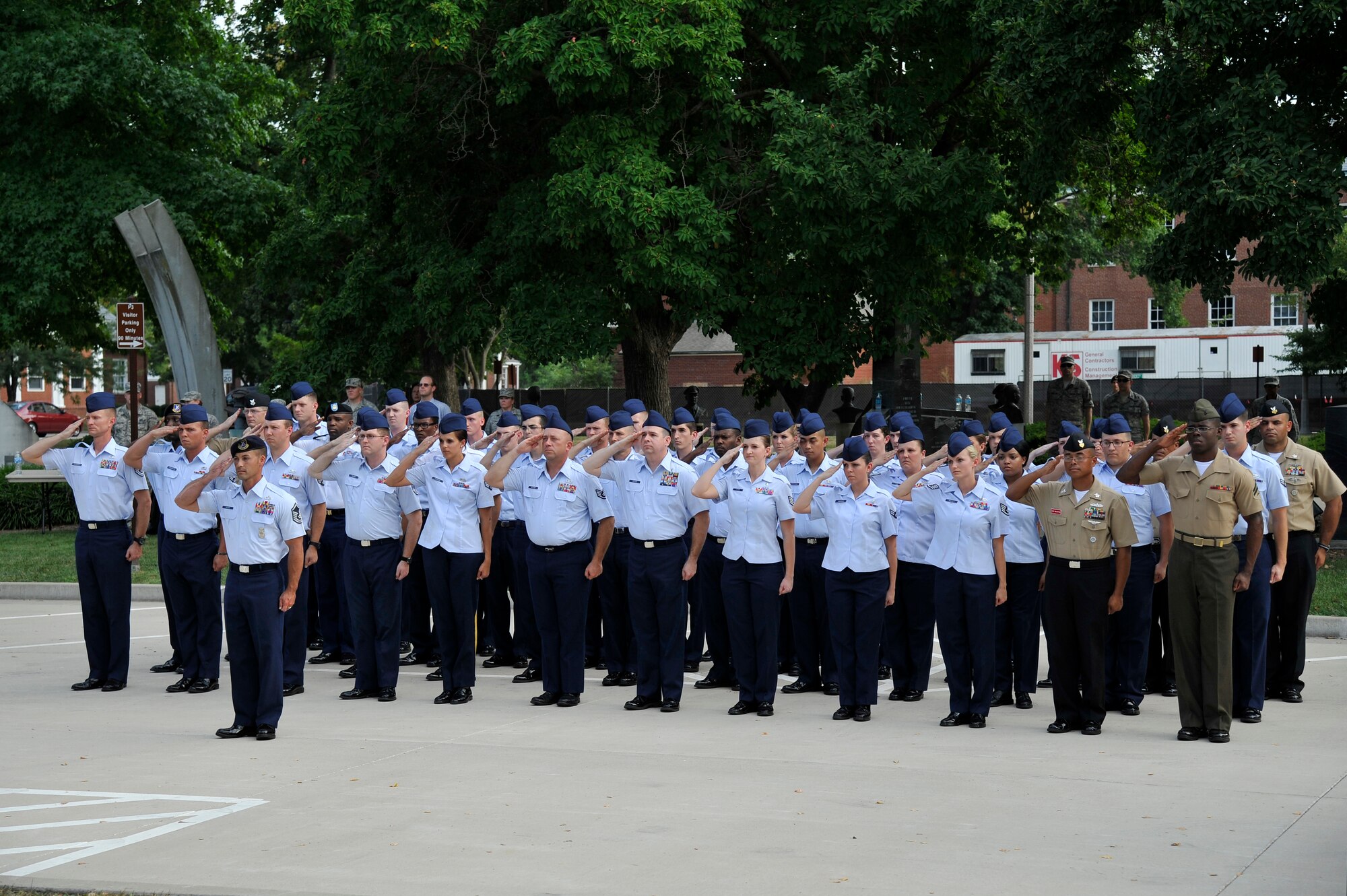 A formation of U.S. service members renders a salute to the U.S. flag during a retreat ceremony honoring the victims of the 9/11 terror attacks Sept. 11, 2012, Scott Air Force Base, Ill. (U.S. Air Force photo/Staff Sgt. Christopher Boitz)