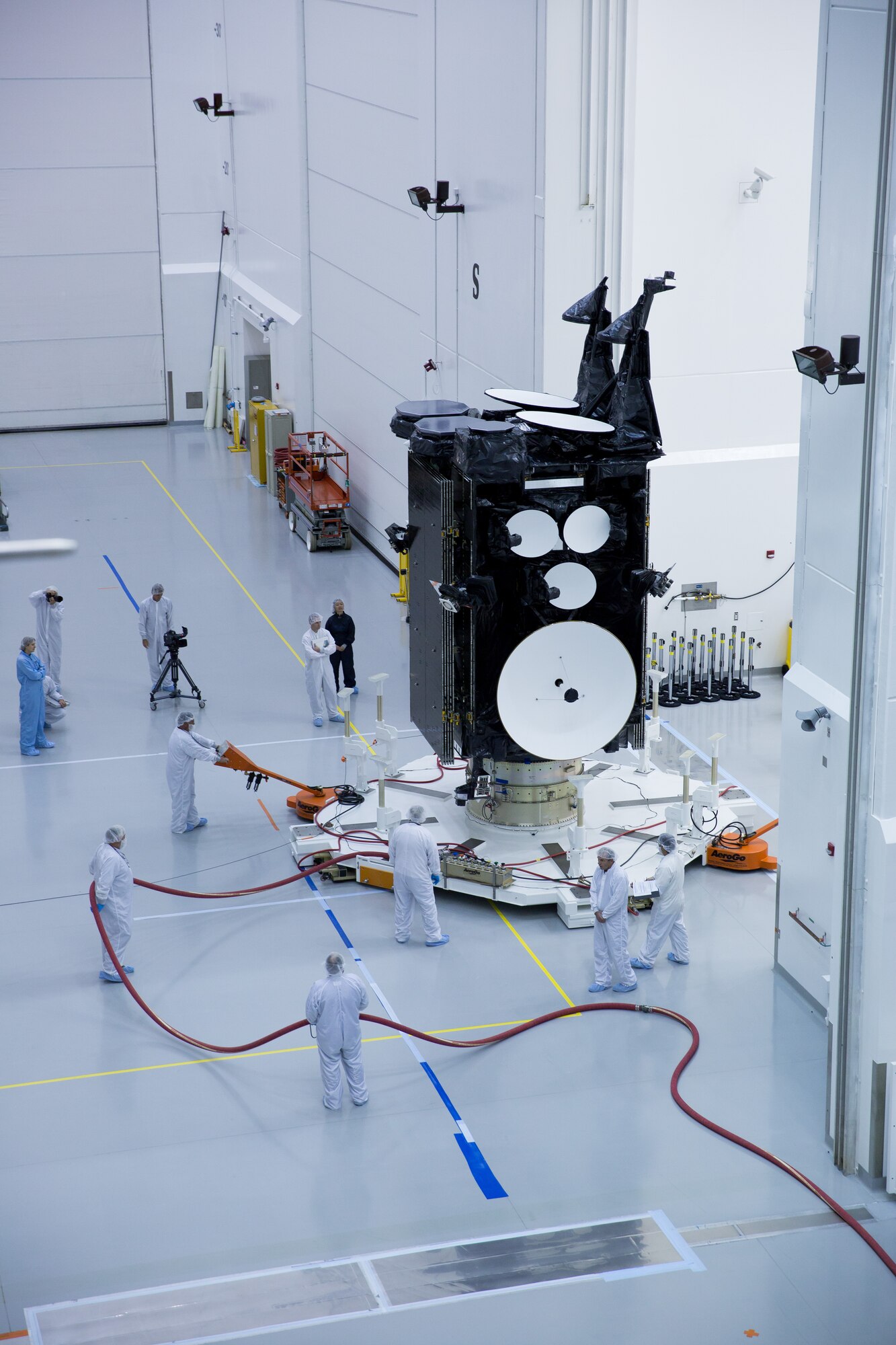 Workers prepare the U.S. Air Force's third Advanced Extremely High Frequency satellite for launch near Cape Canaveral Air Force Station, Fla. The space vehicle was encapsulated into its fairing Aug. 27, 2013, before being mated to an Atlas V rocket. It is scheduled to launch on Sept. 18, 2013.  AEHF is a Joint-service system that provides survivable, near world-wide, secure, protected, and jam-resistant communications for high-priority National military operations. (Photo courtesy of Lockheed Martin)
