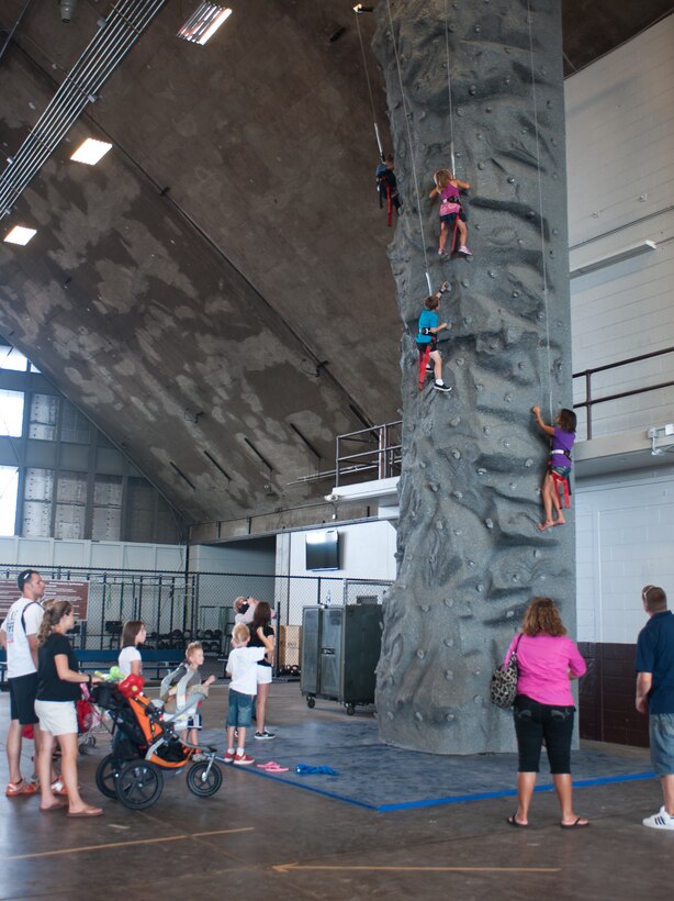 Parents watch as their children scale a rock wall during the annual Back to School Roundup event in the Pride Hangar at Ellsworth Air Force Base, S.D., Sept. 7, 2013. More than 20 base and local organizations provided information about youth programs and assistance available to families with special needs children. (U.S. Air Force photo by Airman 1st Class Alystria Maurer/Released)