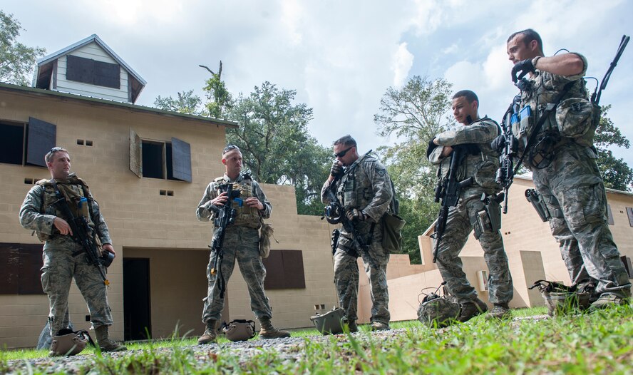 Airmen discuss a shoot-don’t-shoot evaluation as part of tryouts for the Special Reaction Team (SRT) at Moody Air Force Base, Ga., Sept. 6, 2013. Tryouts for the SRT also included physical fitness tests, written tests and marksmanship. (U.S. Air Force photo by Senior Airman Jarrod Grammel/Released)
