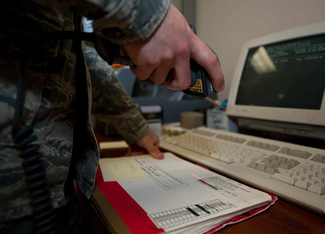 Airman 1st Class Nicholas Ward, 28th Medical Support Squadron medical records technician, scans files prior to scheduled appointments at Ellsworth Air Force Base, S.D., Sept. 6, 2013. Before an appointment, a patient’s medical records are checked out to the doctor for review and updates. (U.S. Air Force photo by Airman 1st Class Alystria Maurer/Released)