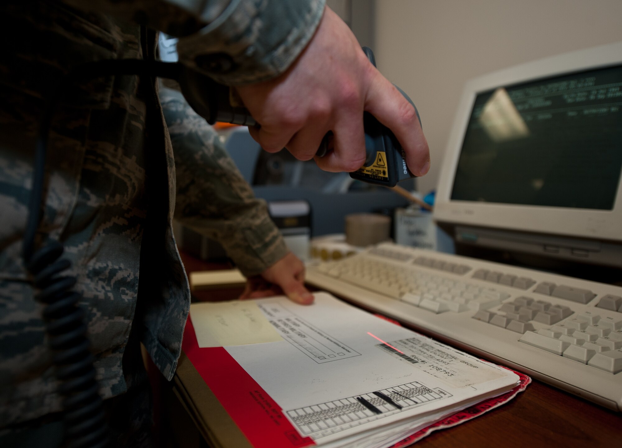 Airman 1st Class Nicholas Ward, 28th Medical Support Squadron medical records technician, scans files prior to scheduled appointments at Ellsworth Air Force Base, S.D., Sept. 6, 2013. Before an appointment, a patient’s medical records are checked out to the doctor for review and updates. (U.S. Air Force photo by Airman 1st Class Alystria Maurer/Released)