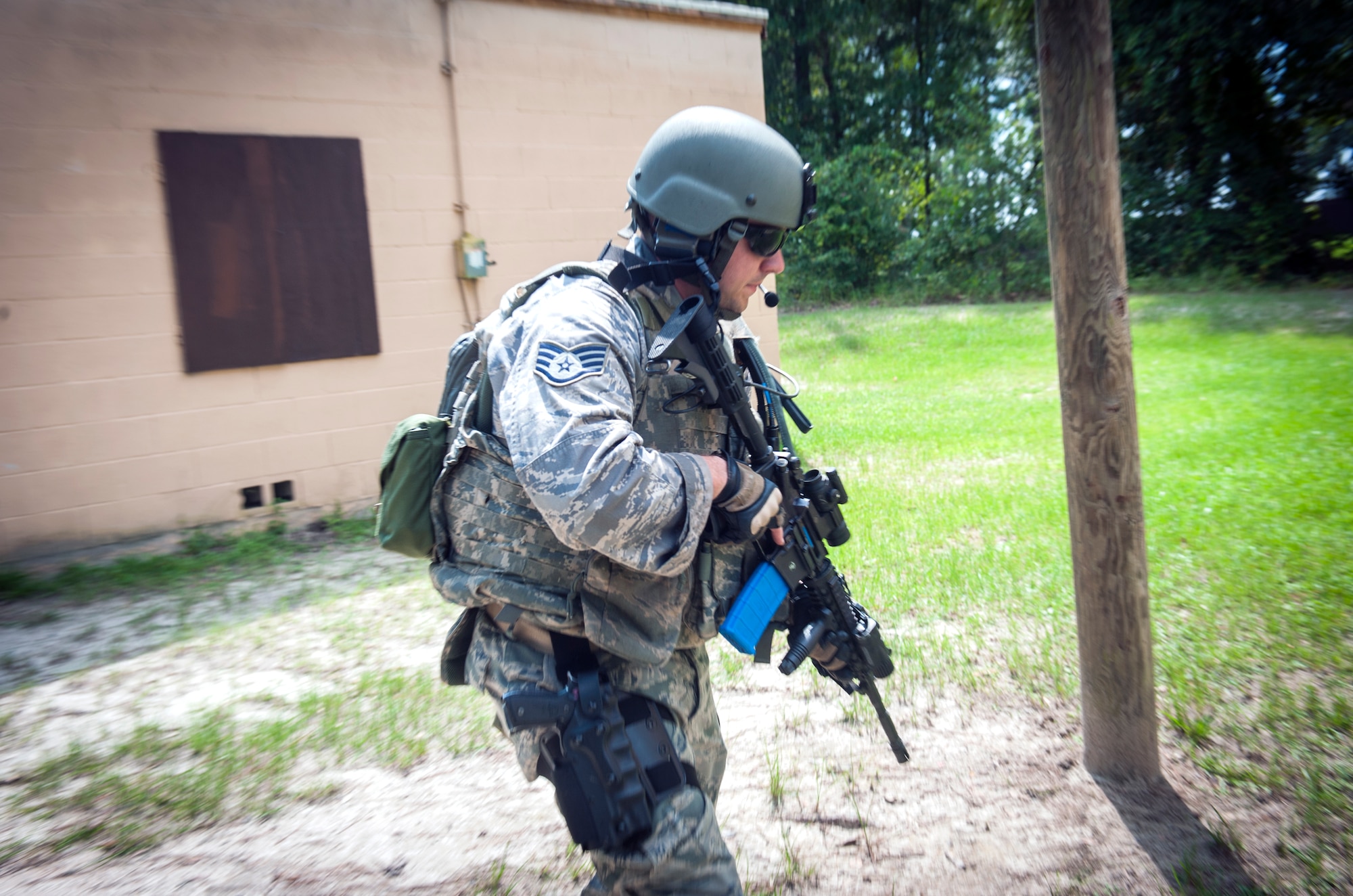 U.S. Air Force Staff Sgt. Marc Robinson, 23d Security Forces Squadron unit trainer, runs between buildings during a shoot-don’t-shoot evaluation at Moody Air Force Base, Ga., Sept. 6, 2013. For the evaluation, Airmen had to clear three buildings by choosing the appropriate level of action to diffuse the situation. (U.S. Air Force photo by Senior Airman Jarrod Grammel/Released)
