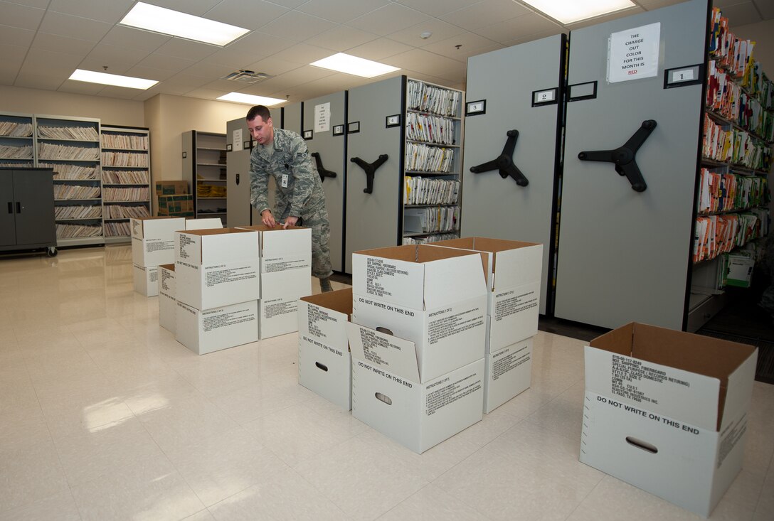 Airman 1st Class Nicholas Ward, 28th Medical Support Squadron medical records technician, pulls inactive records from shelves while retiring files at Ellsworth Air Force Base, S.D., Sept. 6, 2013. The 28th MDSS outpatient records section maintains all Airmen and dependents’ medical records to ensure their accuracy. (U.S. Air Force photo by Airman 1st Class Alystria Maurer/Released)